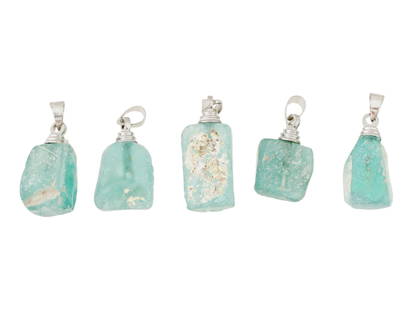 ANCIENT ROMAN GLASS BEADS IN MODERN SILVER SETTING: A lot of 5 ancient Roman glass beads set in modern silver pendant setting. Circa 100 AD. Features a light green color. The glass beads are irregular in shape. Historical Collectibles, Archaeological R