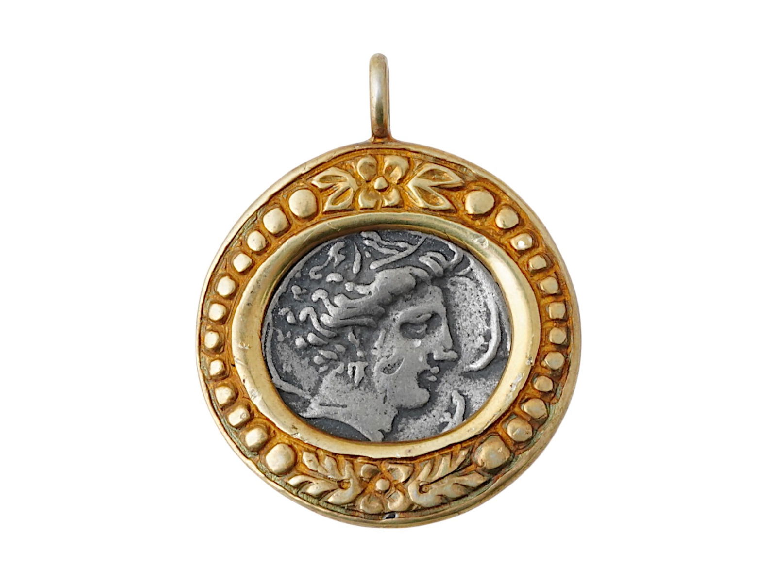 ANCIENT PHOENICIAN CARTHAGE SILVER COIN 320 TO 310 BC: An ancient Phoenician Carthage silver coin set in the modern gold wash over silver setting pendant. The coin features a relief portrait on the obverse and a horse head on the reverse. Circa 320 to 310