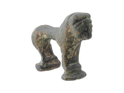 ANCIENT MESOPOTAMIAN BRONZE LION FIGURINE: An ancient Mesopotamian stylized bronze lion figurine. Circa 1200 BC. A powerful symbol of royalty, strength, and protection in ancient Mesopotamian culture, this figurine likely served as a votive of