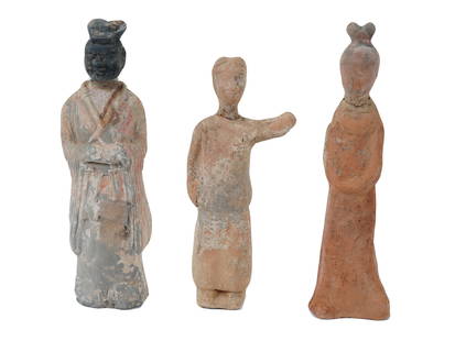 ANCIENT CHINESE HAN DYNASTY TERRACOTTA FIGURINES: A lot of three ancient Chinese Han Dynasty painted terracotta figurines, dating from around 100 to 200 AD. The figurines are presented in a standing pose, dressed in traditional Han attire. The terrac