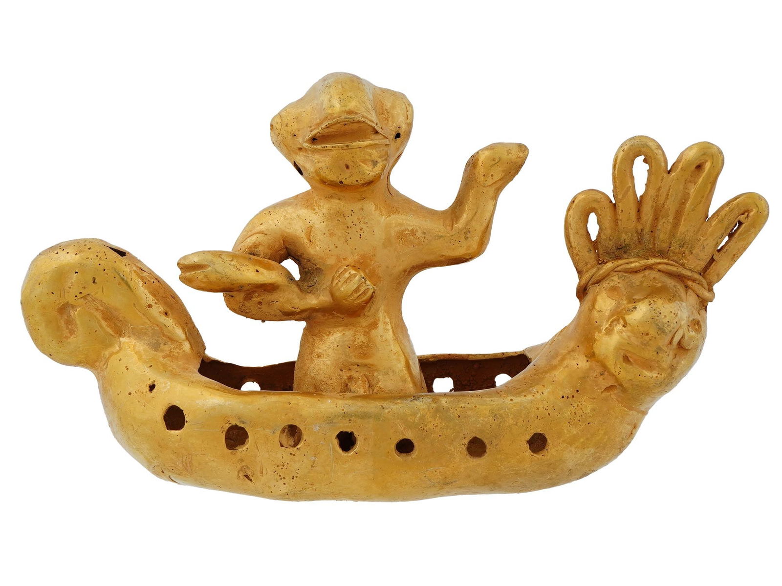 SOUTH AMERICAN QUIMBAYA TUMBAGA CANOE FIGURINE: South American Quimbaya tumbaga figurine representing a canoe with a figure holding a fish. Tumbaga, an alloy of gold and copper, was commonly utilized by Indigenous cultures for crafting various obje