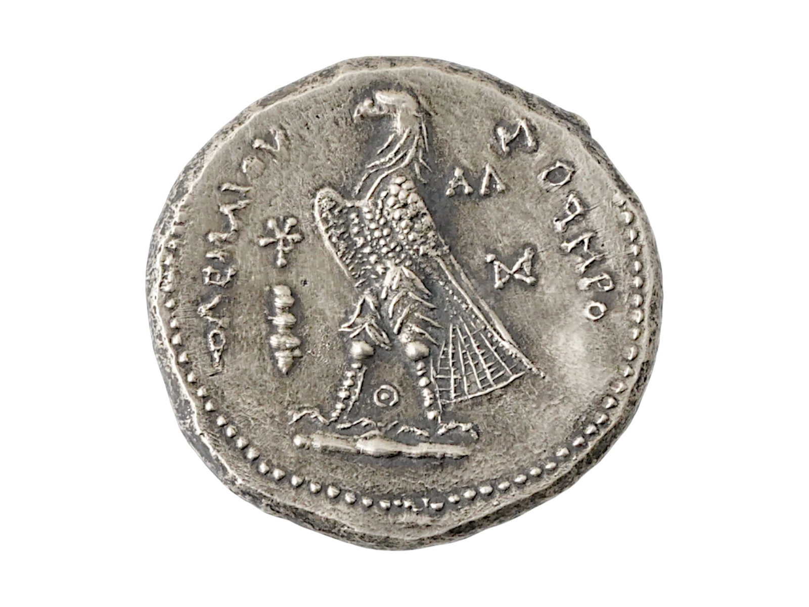 ANCIENT EGYPTIAN PTOLEMY SILVER TETRADRACHM COIN: An ancient Egyptian Ptolemy silver Tetradrachm coin. The obverse depicts a portrait of the ruler. Circa 305 to 30 BC. The reverse depicts an eagle, symbol of Zeus standing with folded wings, surrounde