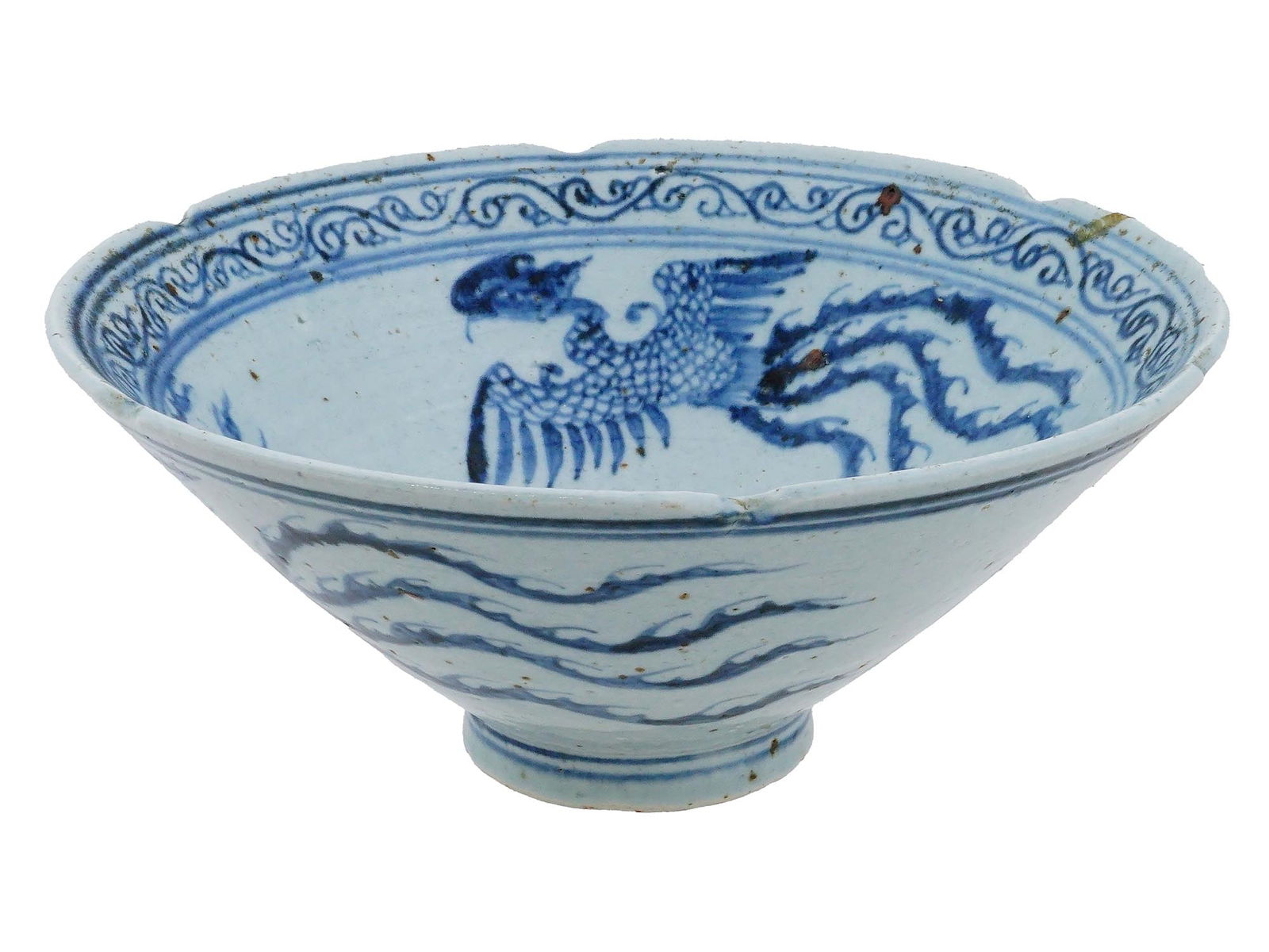 CHINESE PHOENIX FOOTED BLUE AND WHITE CERAMIC BOWL: A Chinese footed blue and white ceramic bowl. The exterior and interior of the bowl are decorated with a Phoenix bird design. The interior is adorned with a foliate scroll ornament on the borders and