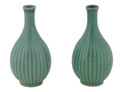 TWO VINTAGE CHINESE CELADON GLAZED SAKE BOTTLES: A pair of vintage Chinese ceramic celadon ware sake bottle vases of a traditional melon or gourd form shape, covered with a beautiful sage green glaze with fine crackle finish. Each piece is marked on
