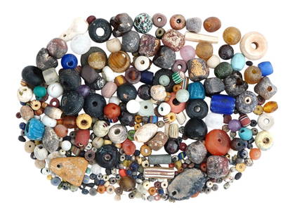 ANCIENT MEDITERRANEAN GLASS STONE BEADS COLLECTION: A large collection of Ancient beads made of glass, shell, amethyst, stone, carnelian, garnet, and faience. Mediterranean, after 1000 BC. Various shapes. Historical Collectibles And Archaeological Reli