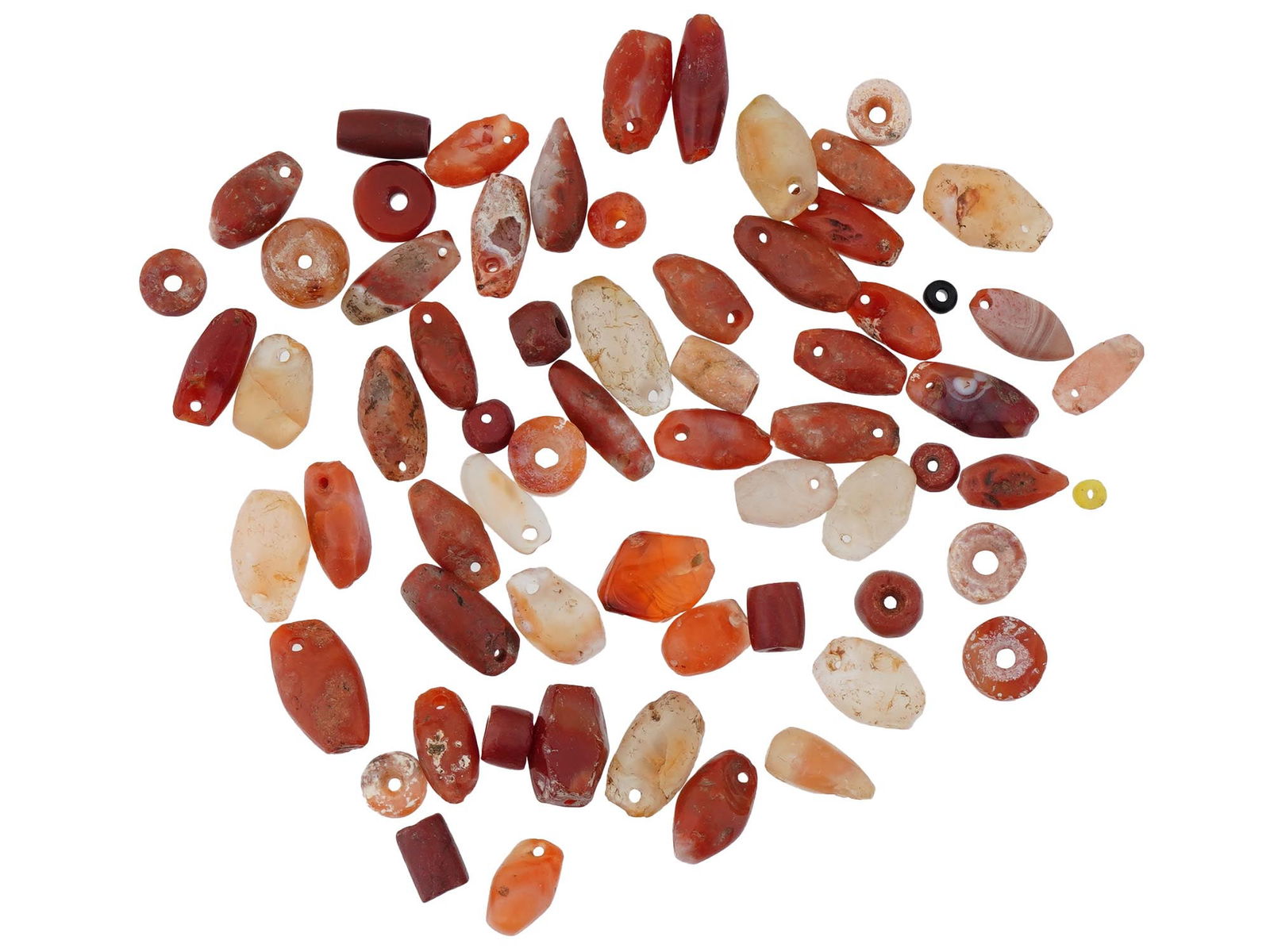 ANCIENT CARVED AGATE AND CARNELIAN PENDANTS AND BEADS: A group of ancient carved agate and carnelian pendants and beads dating to the 1st millennium BC, featuring both prolonged and rounded forms. These pieces showcase the natural banding of agate and the