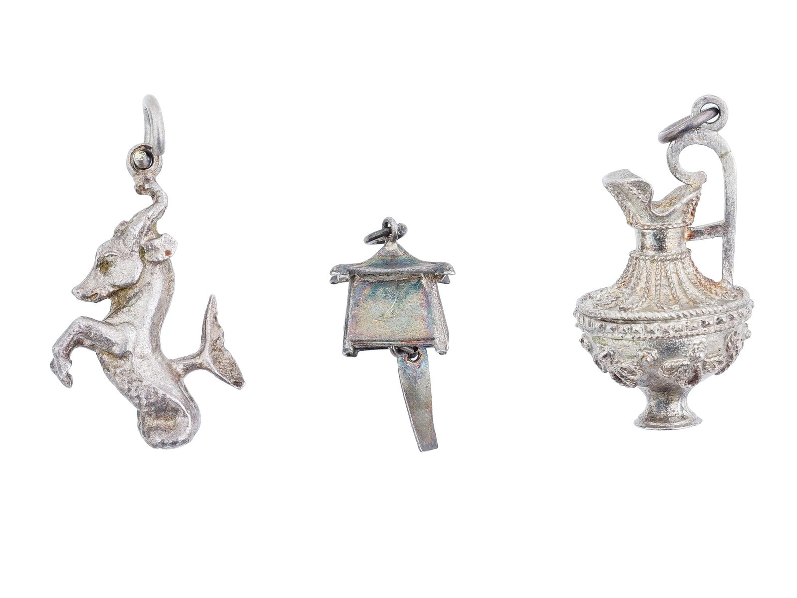 VINTAGE FIGURATIVE JEWELRY CHARMS: A lot of 3 vintage metal charms representing a pitcher, a seahorse, and a cottage house. Unmarked. Collectible Jewelry And Souvenirs. THIS LOT QUALIFIES FOR A 30-DAY UNCONDITIONAL RETURN FROM T