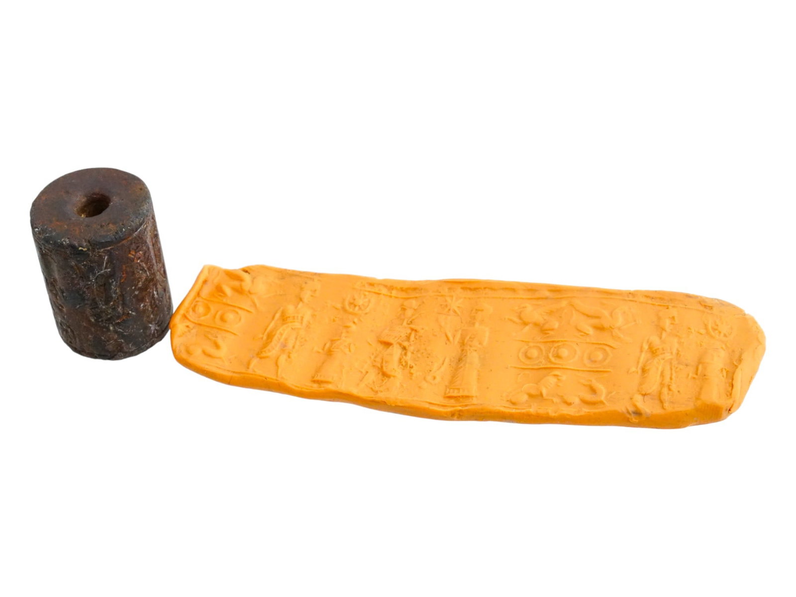 1ST MILLENNIUM BC NEAR EASTERN STONE CYLINDER SEAL: A Near Eastern, probably Akkadian, hand carved hard stone cylinder seal. The imprint depicts a contest scene with human figures and mythological creatures. Circa: 1st Millennium BC. Antique Seals, His