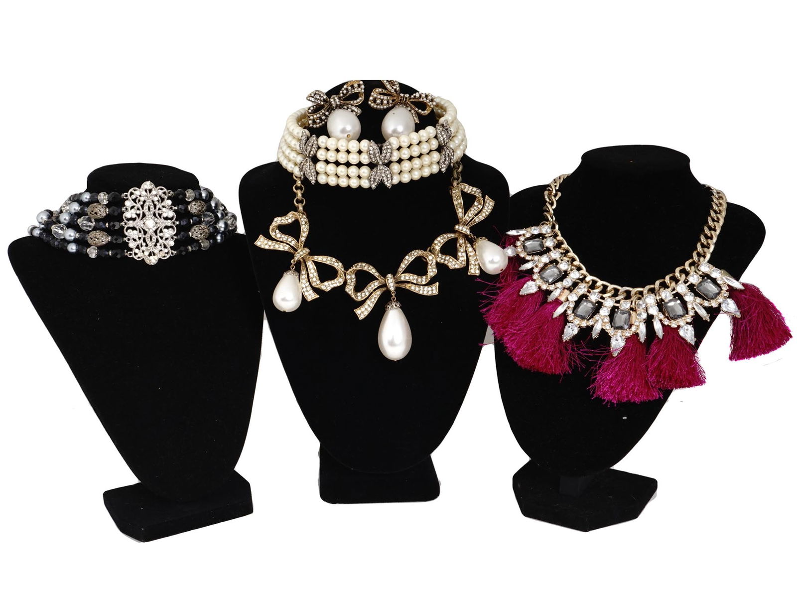 COLLECTION OF FIVE CUSTOM JEWELRY NECKLACES: A collection of five custom jewelry necklaces. The necklaces are made in bows and scrollwork designs, adorned with pearls, faux diamonds, stones, and fringe tassels. One os marked, Craft Co. Circa: 20