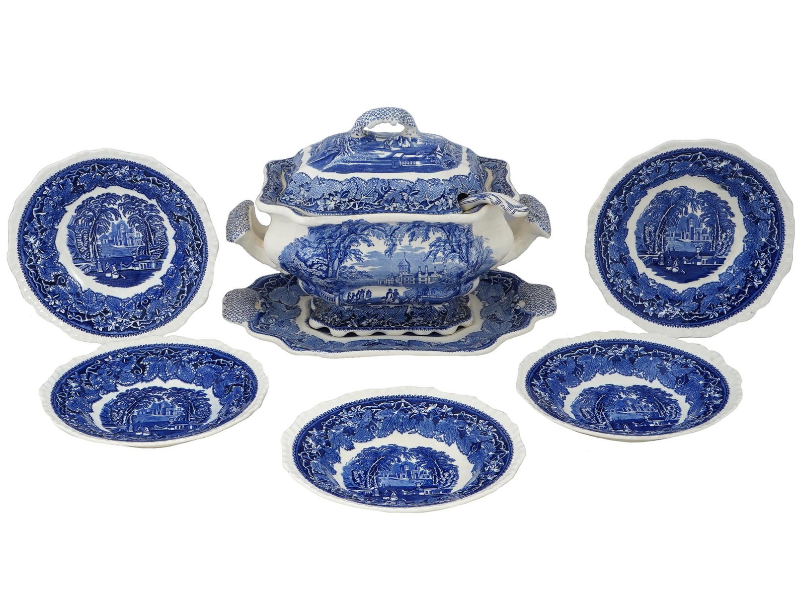 MASONS IRONSTONE BLUE AND WHITE VISTA TABLEWARE: A mid-20th century ironstone china tableware set by Masons, a renowned English company established in 1813. Ca. 1940s. A total of 7 items, 5 dinner plates, a lidded tureen, and a ladle. Cobalt blue tr