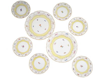 ANTIQUE GERMAN MEISSEN PORCELAIN FLOWER PLATE SET: An antique German Meissen porcelain set in yellow and white, including two elegant dinner plates and six charming dessert plates, each adorned with exquisite flower patterns and accented by gilded rim