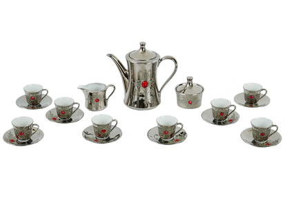MID CENT SELTMANN WEIDEN GERMAN PORCELAIN TEA SET: A mid 20th century West German porcelain silver tone tea set. The tea set has an interesting design, the outer side of each item is silver in tone with the image of a stylized star in the center of wh