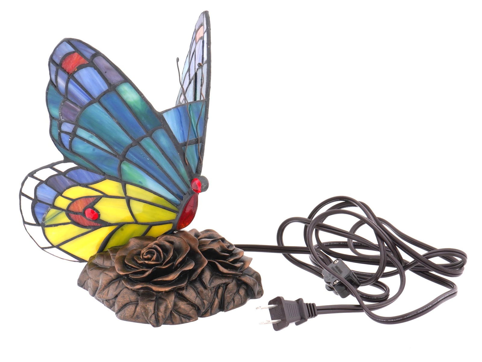 TIFFANY STYLE STAINED GLASS BUTTERFLY DESCK LAMP: A nice vintage Tiffany style table or desk lamp hand crafted of polychrome pieces of stained glass in the form of a butterfly. Decorated with beautiful red cabochon accents. Raised on a cast metal bas