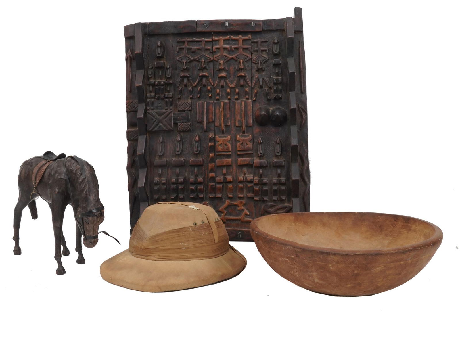 VINTAGE ETHNOGRAPHIC WOOD ART COLLECTIBLES: A Dogon door made of wood from the region of Toro, at the extreme east of the Bandiagara cliff. The door is decorated with carved tribal ornaments. Dogon people are mainly located in the administrativ