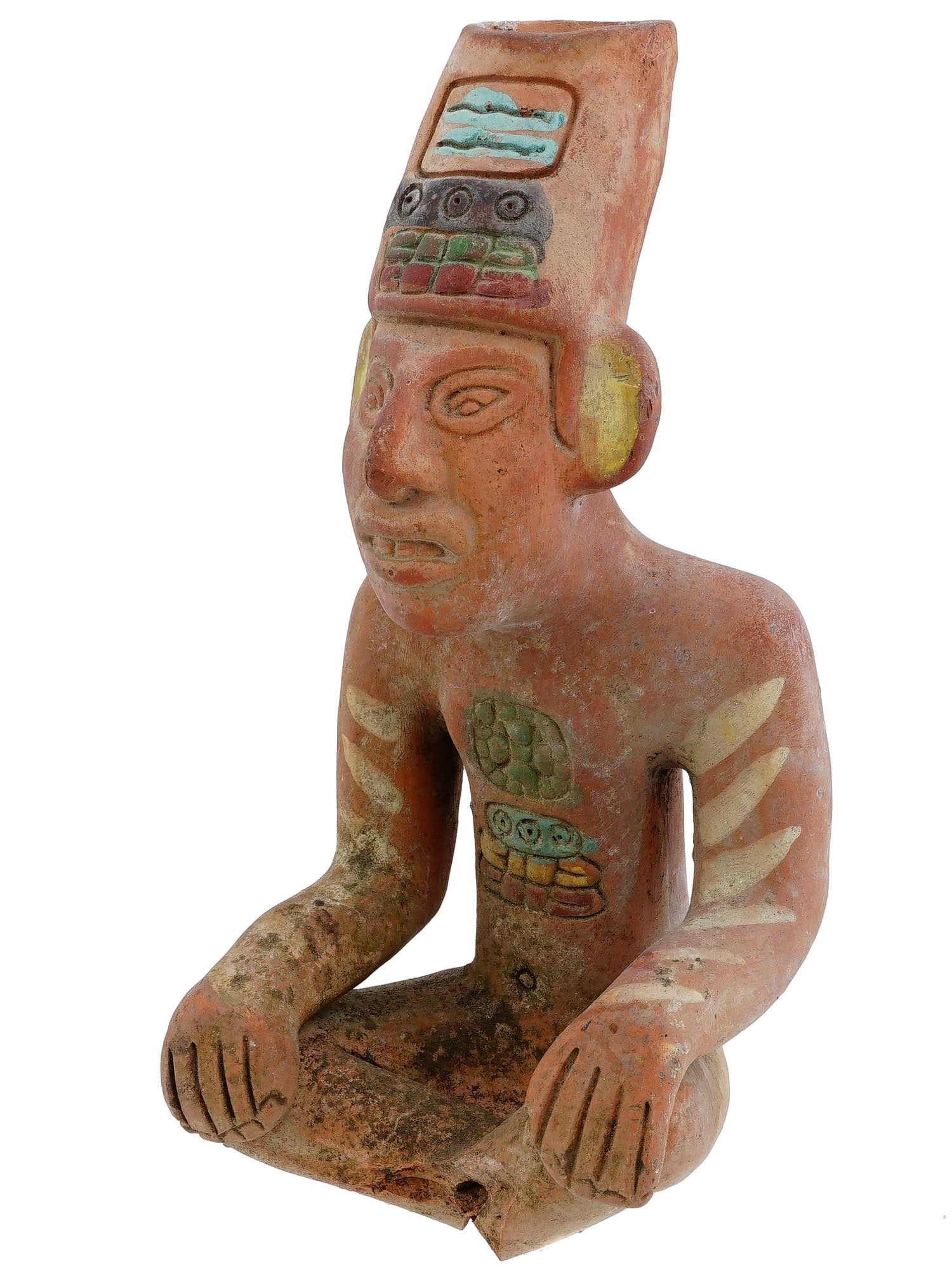 PRE COLUMBIAN MESOAMERICAN TERRACOTTA IDOL FIGURE: An ancient Pre Columbian Mesoamerican terracotta idol figure. The figure depicts a seated figure of a man with engraved facial features and dressed in a high headdress, adorned with engraved ornaments