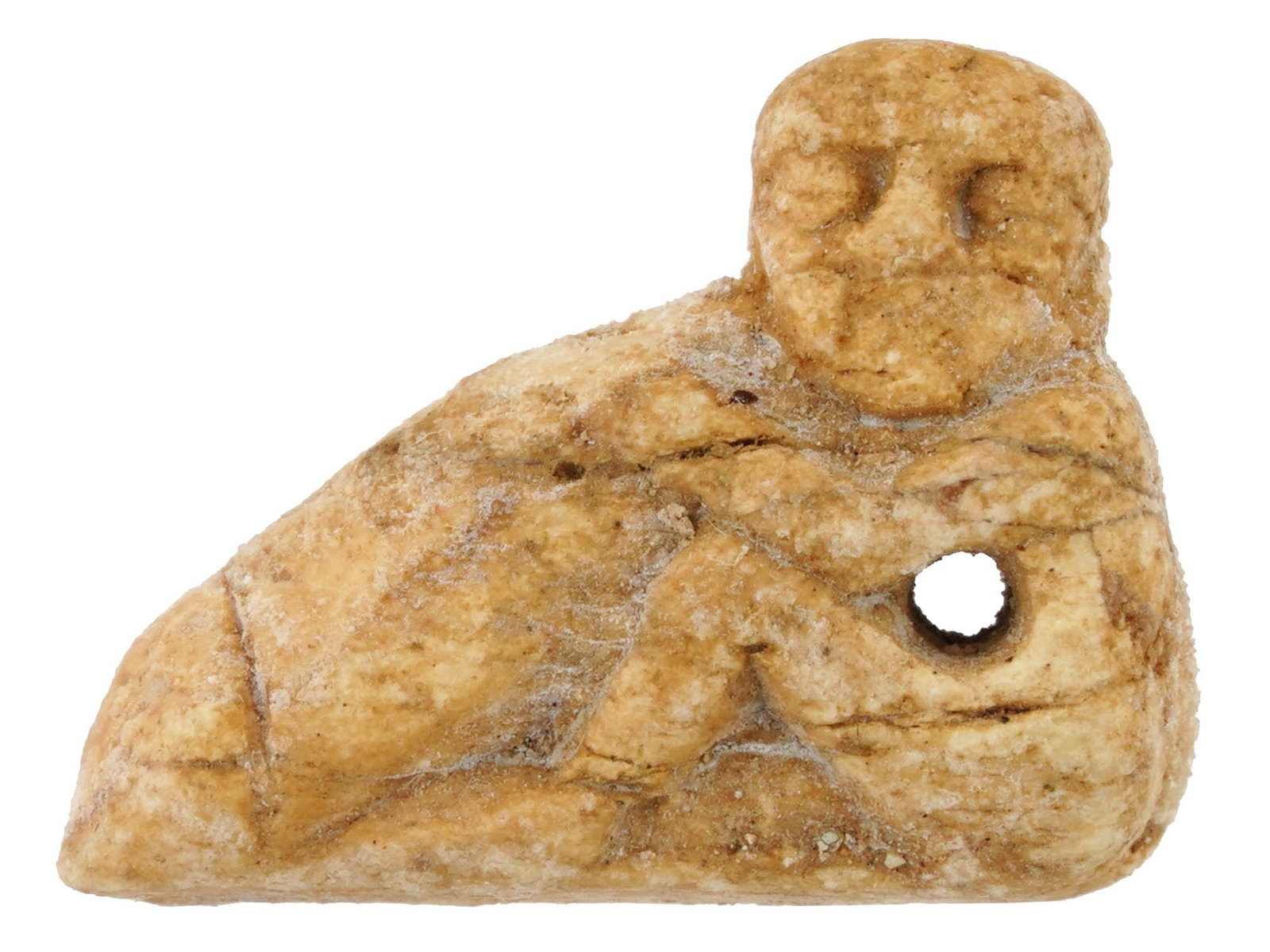 EGYPTIAN HAND CARVED NATURAL MATERIAL EROTIC PENDANT: A Egyptian hand carved from natural material figural pendant made in the ancient manner. The pendant represents an erotic figure, carved with detailed patterns. An opening for wearing to the center ri