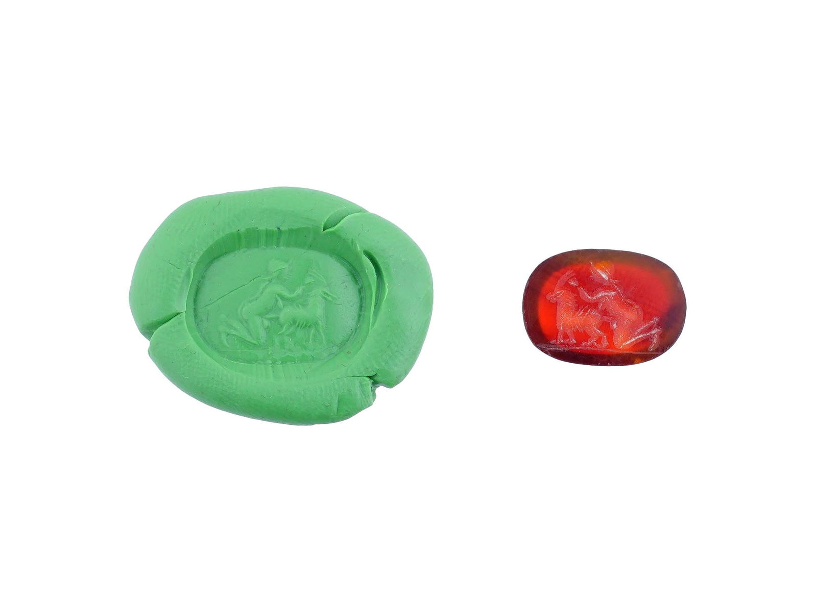 CARVED STONE INTAGLIO ANCIENT ROMAN EROTIC SCENE: A carved carnelian stone intaglio featuring a depiction of an ancient Roman erotic scene involving a man and a goat. This intricately detailed engraving reflects the artistic and symbolic traditions o