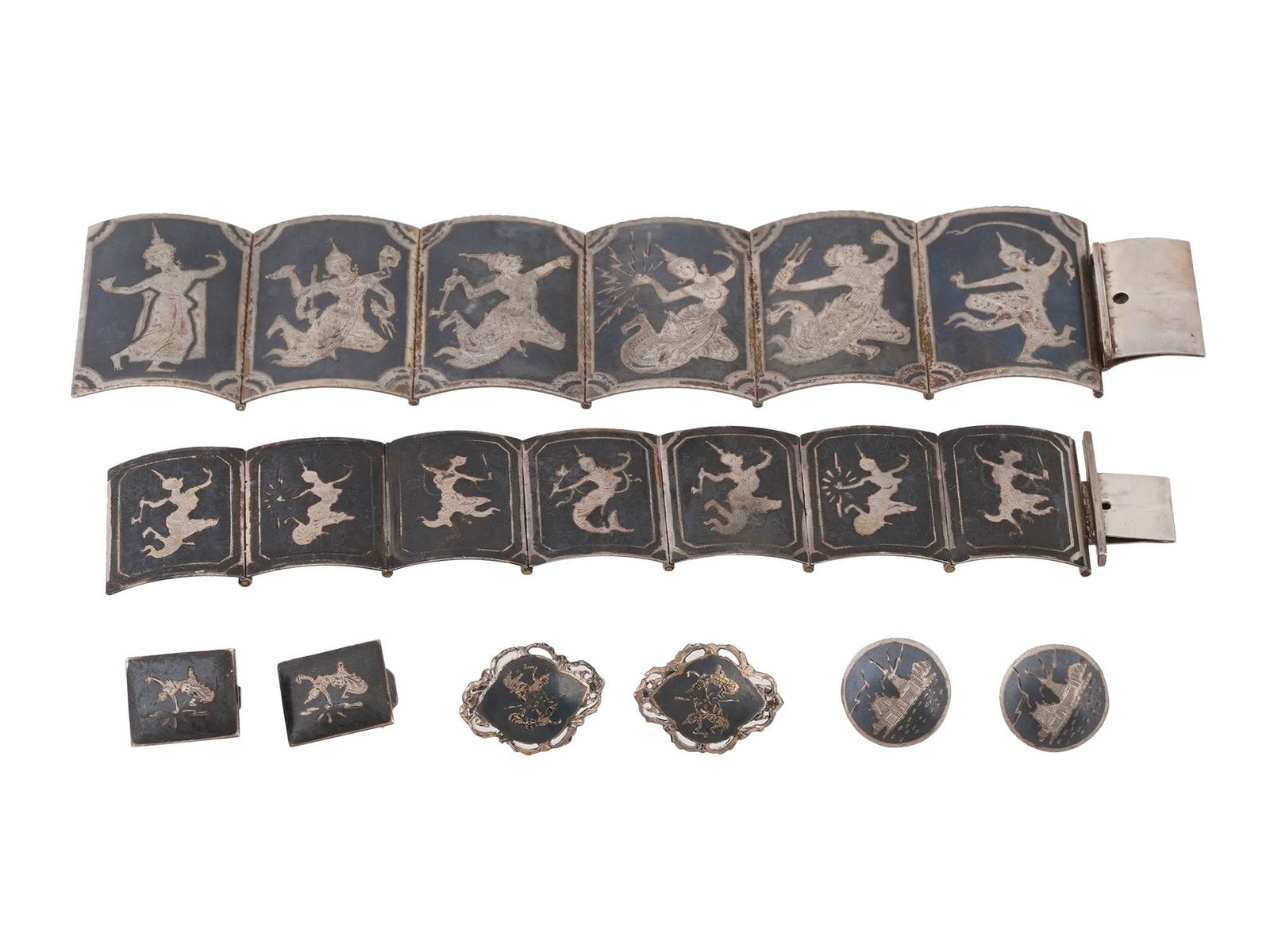 LOT OF THAI SIAM STERLING SILVER NIELLO JEWELRY WARES: A collection of five Thai Siam Sterling Silver and Niello jewelry wares. The collection includes earrings, cufflinks and bracelets. The wares are adorned with Buddhist Religious and female figures des