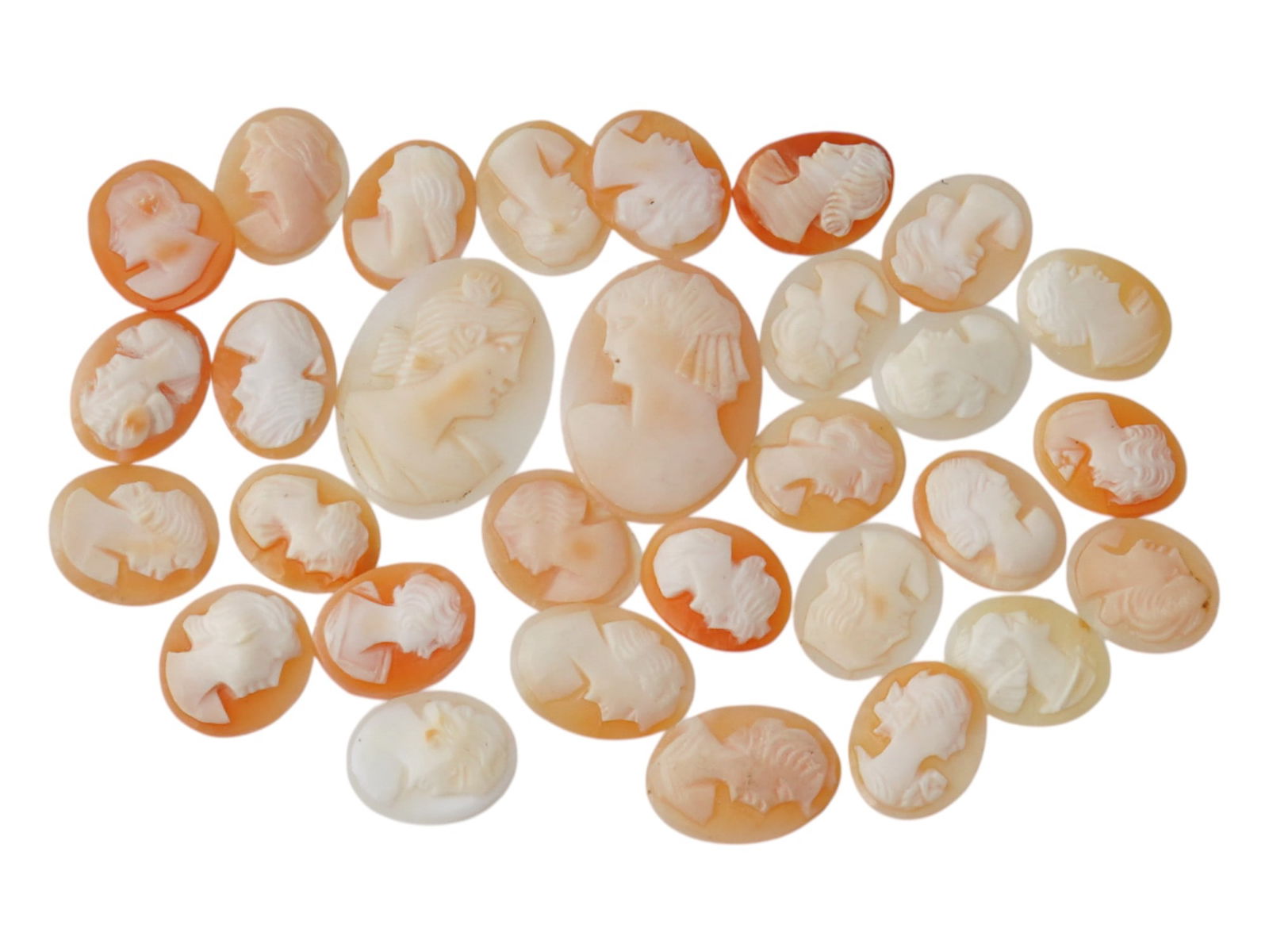 COLLECTION OF ANTIQUE HAND CARVED CAMEOS: A collection of antique hand carved cameos, dating to the late 19th to early 20th century. A total of 30 items. Each piece is crafted from conch shell, featuring female portraits rendered in high reli