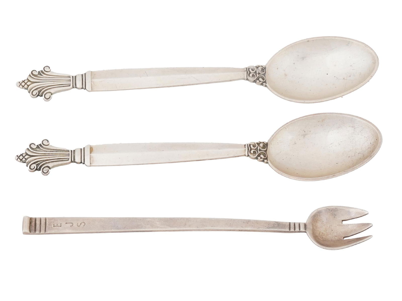 STERLING SILVER JEAN GEORGE SPOONS TIFFANY AND CO FORK: A lot of three sterling silver utensils. Two are Jean George matching spoons with ornamental handles, marked Jean George, Sterling Denmark. The third is a Tiffany and Co fork, engraved with letters on
