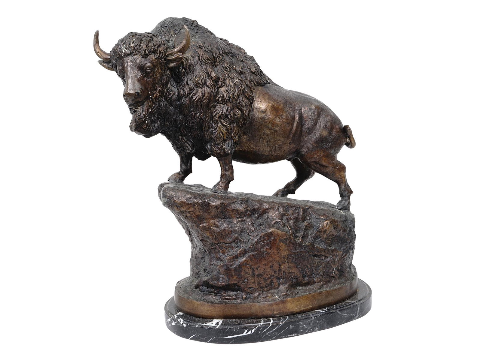 AMERICAN PATINATED BRONZE BUFFALO SCULPTURE: A Modern American patinated bronze sculpture in the shape of a buffalo standing on a rock in the manner of Charles Marion Russell. The sculpture is adorned with textured fur, forward facing, mouth aja