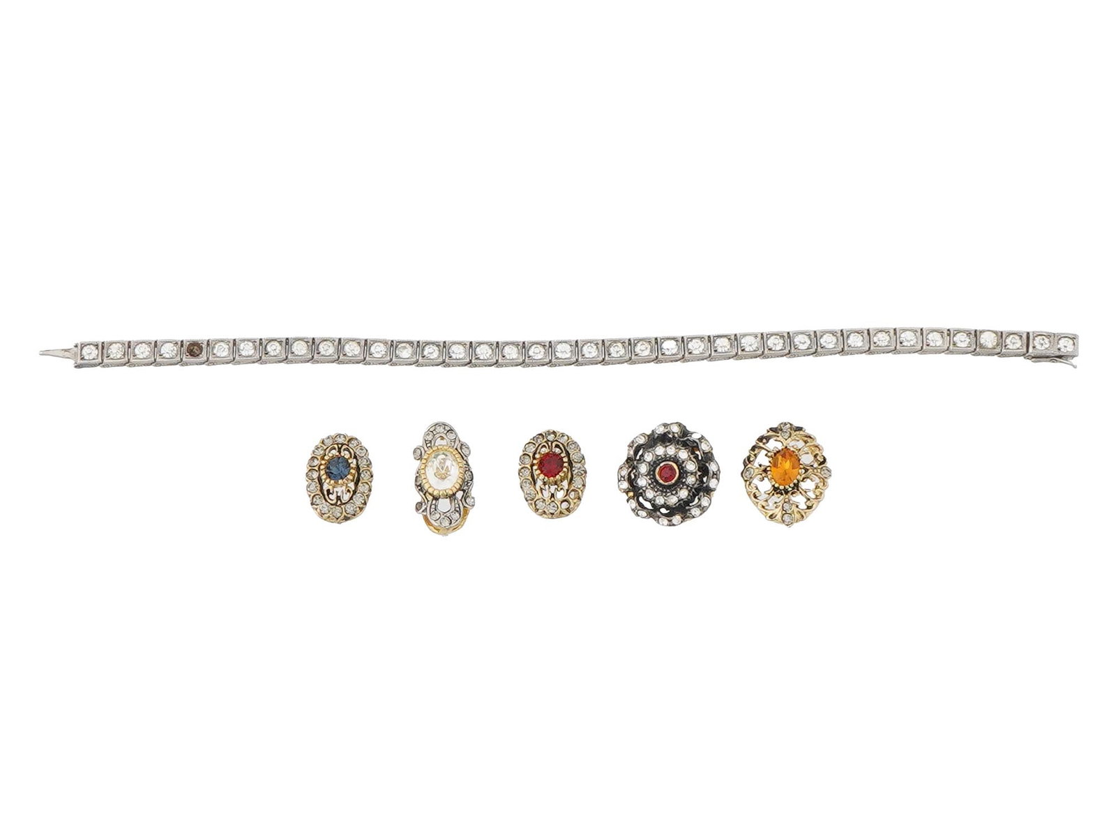 SILVER VINTAGE BRACELET W STONES AND JEWELRY PIECES: A collection of silver vintage jewelry pieces, including a delicate bracelet and five ornate pieces. The bracelet is crafted with a series of small, square shaped settings, each containing a clear gem
