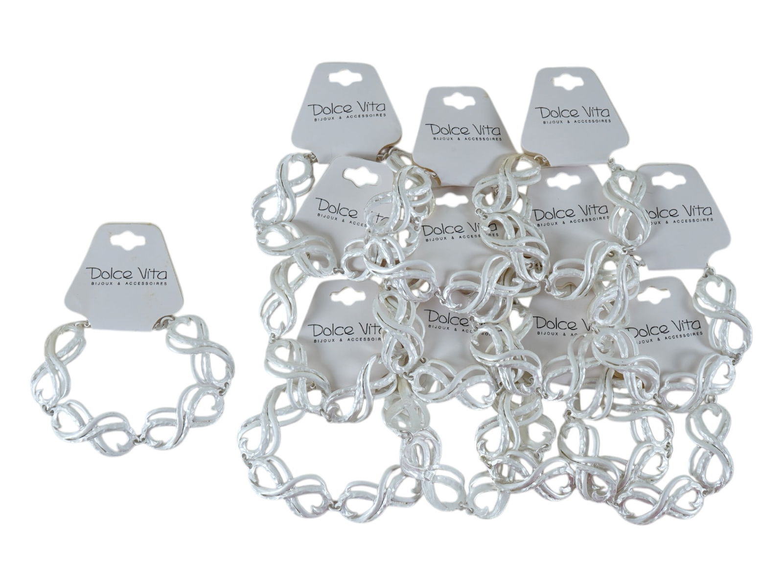 VINTAGE FRENCH DOLCE VITA COSTUME JEWELRY BRACELETS: A vintage French Dolce Vita costume jewelry set, comprising 12 silver-toned bracelets featuring a chain design. All are displayed on their original white cardboard card marked with the brands logo. Ci