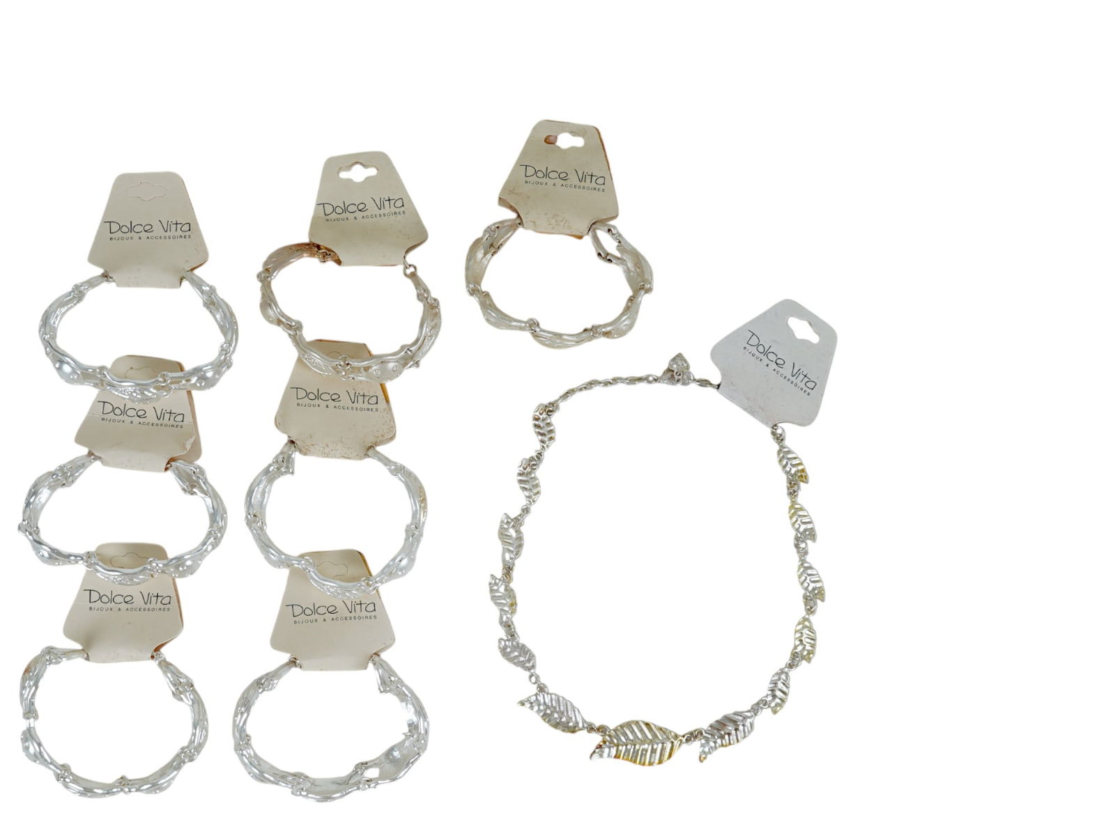 LOT OF FRENCH DOLCE VITA BRACELETS AND NECKLACE: A lot of vintage French Dolce Vita costume jewelry, a total of 7 silver-tone link bracelets and one necklace. Ca. 1980s. Original labels are preserved. The links are shaped as tree leaves. Dolce Vita