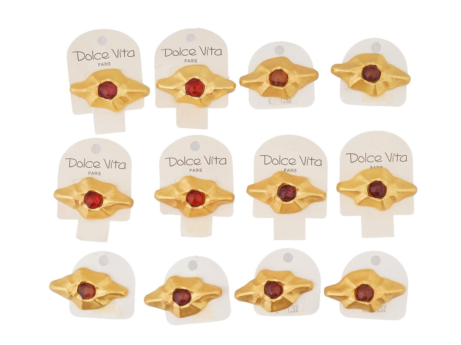 VINTAGE FRENCH DOLCE VITA COSTUME JEWELRY BROOCHES: A vintage French Dolce Vita costume jewelry set, including 12 brooches. The brooches have a stylized, abstract design with a central red colored stone and a textured gold toned metal surrounding it. D