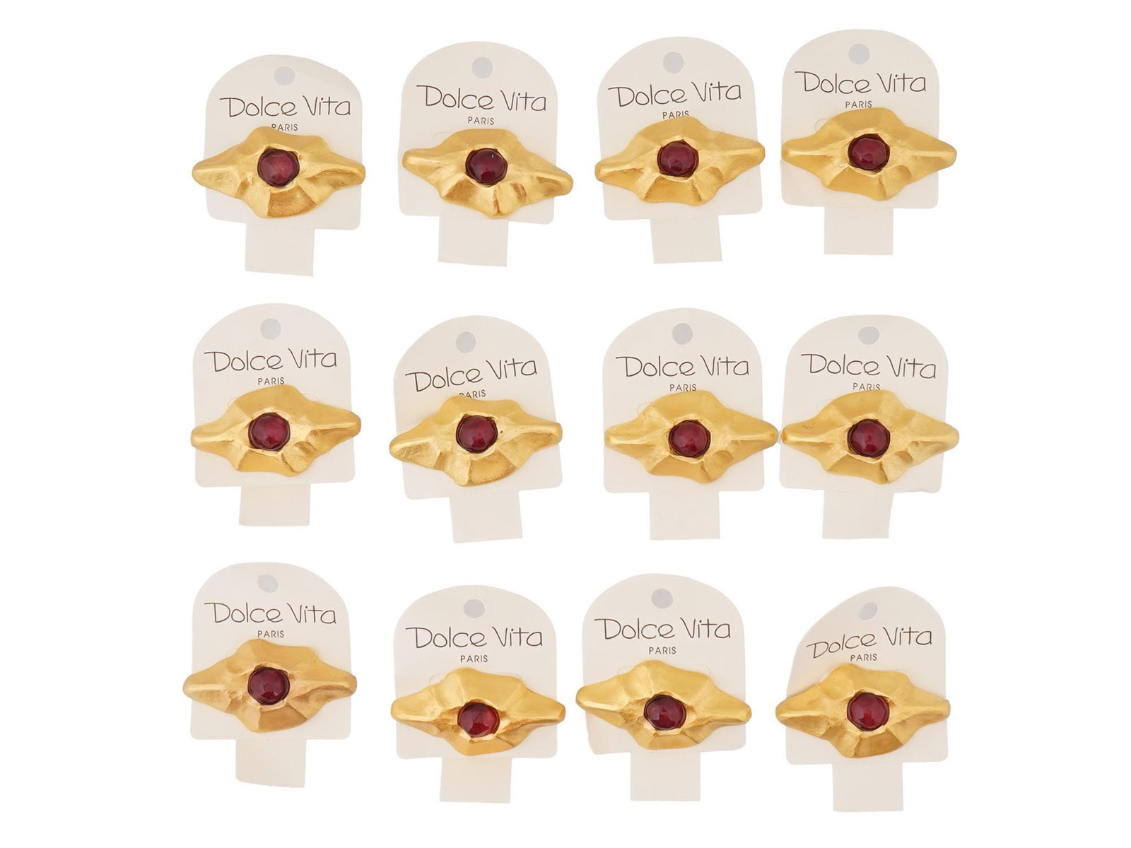 VINTAGE FRENCH DOLCE VITA COSTUME JEWELRY BROOCHES: A vintage French Dolce Vita costume jewelry set, including 12 brooches. The brooches have a stylized, abstract design with a central dark red colored stone and a textured gold toned metal surrounding 
