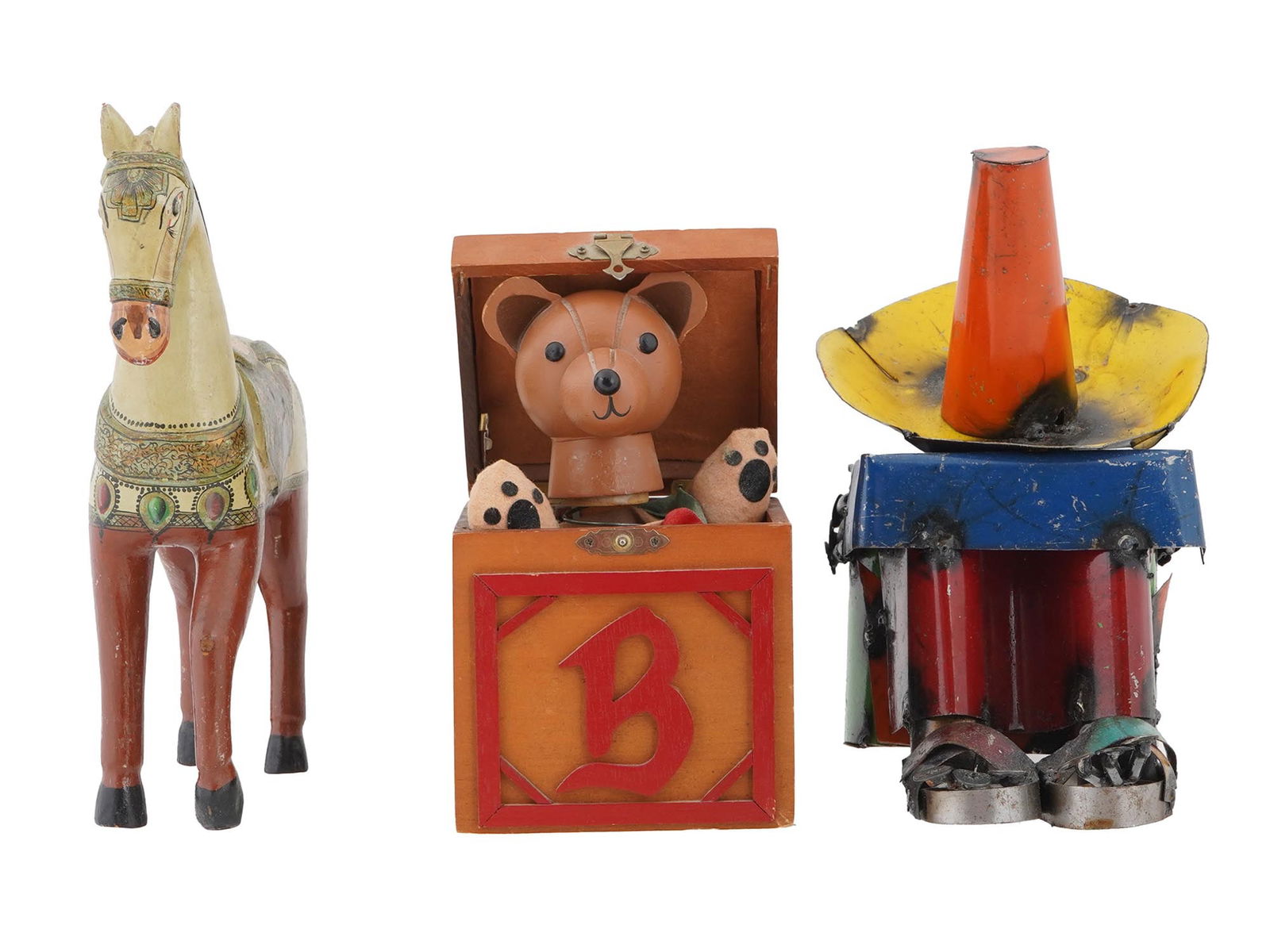 GROUP OF THREE VINTAGE CHILDREN TOYS: A group of three vintage toys. An Indian style hand painted wooden horse with detailed decorations on its saddle. A jack-in-the-box featuring a teddy bear. The box has a picture of a rocking horse on
