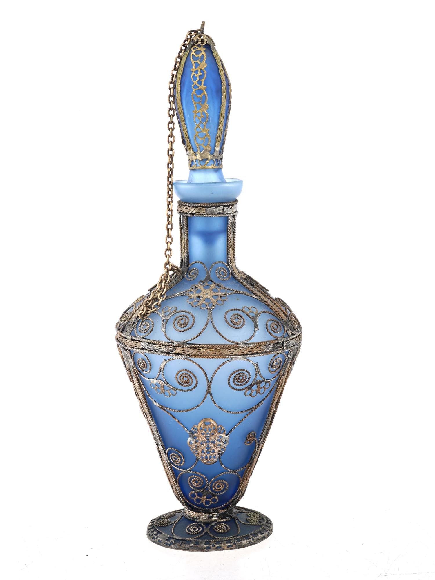 VTG BLUE FROSTED GLASS AND SILVER PLATE DECANTER: A vintage mid-20th century blue frosted glass decanter with stopper. Silver-plated filigree fittings. Chain holder. Unmarked. Collectible Glassware, Tableware And Serveware. THIS LOT QUALIFIES