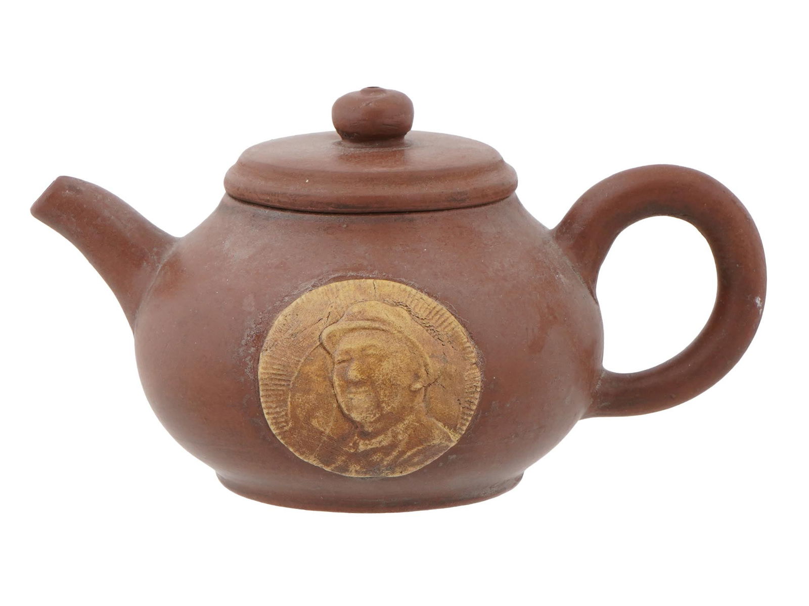 VINTAGE CHINESE COMMUNIST PROPAGANDA YIXING CLAY TEAPOT: A vintage Chinese Yixing clay teapot dating to the Cultural Revolution period, circa 1960s and 1970s, crafted from traditional zisha purple clay. The body features a raised medallion with a portrait o