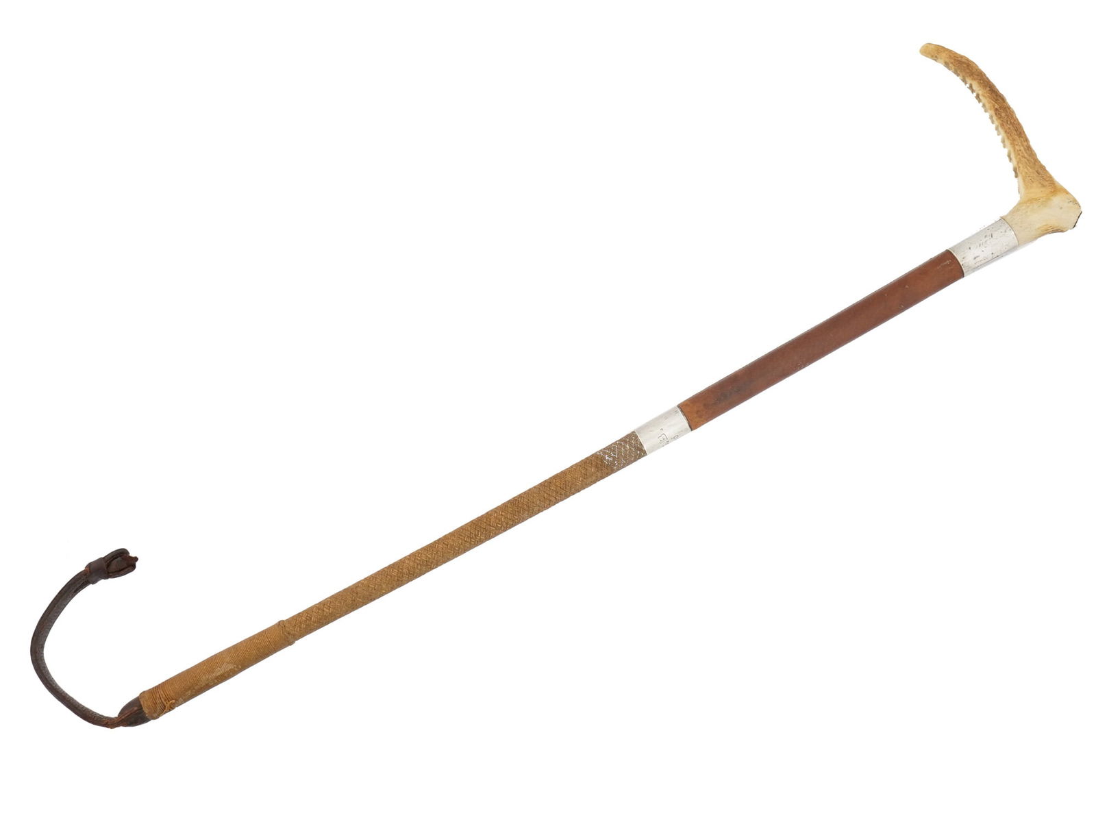 ANTIQUE LEATHER SILVER AND HORN HUNTING WHIP BY SWAINE: An antique English hunting whip by Swaine. The handle is made of horn with a distinct curve and a ridged texture. A section of the handle is covered in dark brown leather, with a thin band made of ste