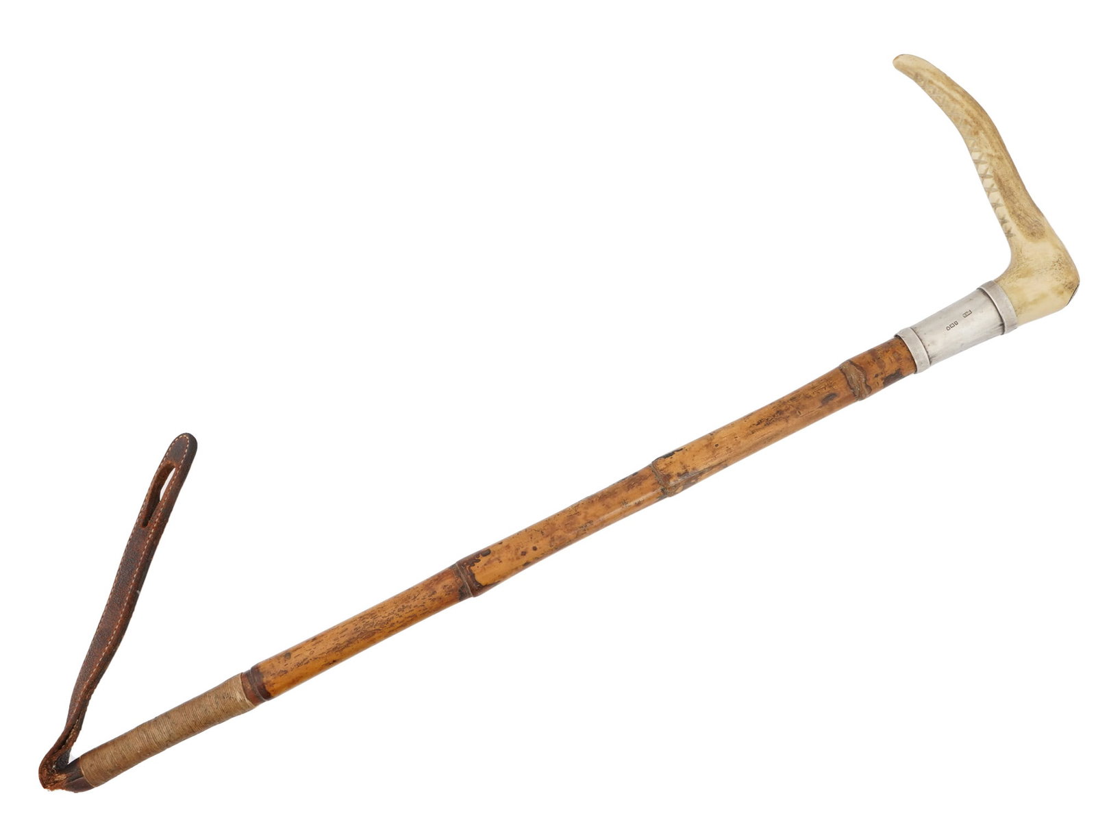 ANTIQUE SILVER HORN LEATHER HUNTING WHIP BY SWAINE: An antique English hunting whip by Swaine and Adeney. The handle is made of horn with a distinct curve and a ridged texture. The shaft is made of bamboo with a thin band made of sterling silver. The t
