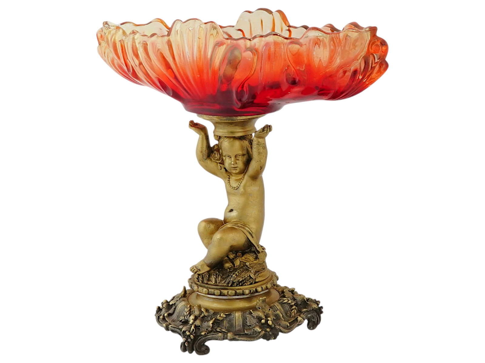ANTIQUE FRENCH BRONZE AND GLASS VASE WITH CHERUB: An antique French bronze and glass vase adorned with a cherub. The cherub is depicted in a playful pose, sitting with one hand raised and the other resting on its knee and supporting a glass oval flor
