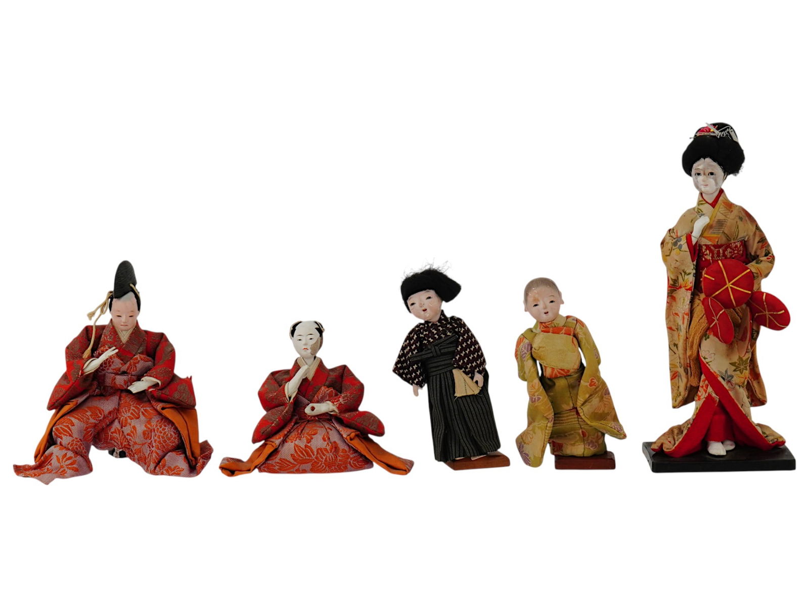 GROUP OF FIVE JAPANESE CLAY AND FABRIC DOLLS W STANDS: A group of five Japanese clay dolls. The dolls are made of fabric and clay, with painted faces. They wear traditional Japanese clothing and are each posed differently, with two of the dolls seated and