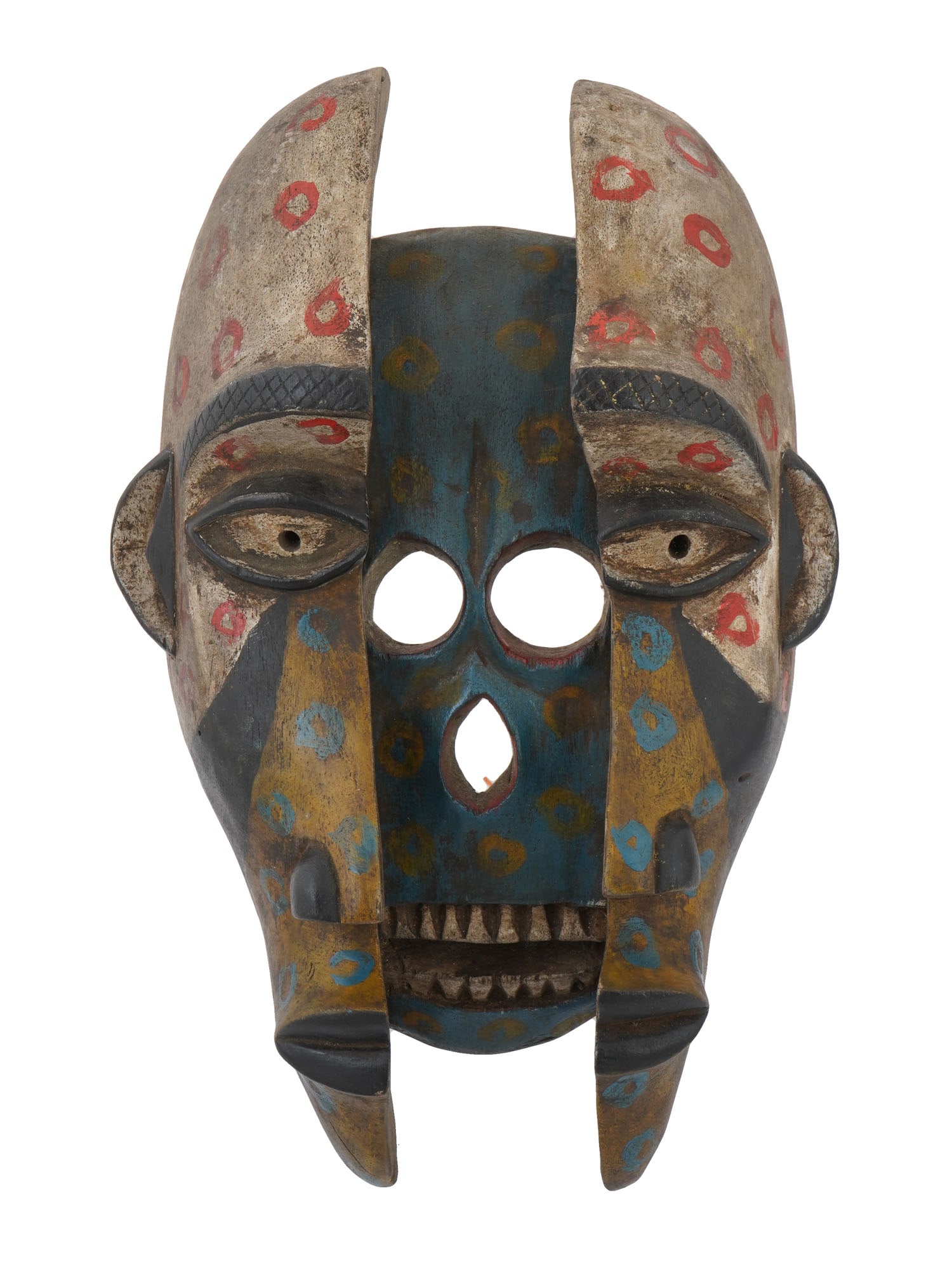 CENTRAL AFRICA CONGO SPIRITUAL HAND PAINTED WOODEN MASK: A spiritual hand carved and painted wooden mask from Central Africa, Congo. It features a symmetrical design with two halves. Each side displays distinct painted patterns, including a forehead area wi