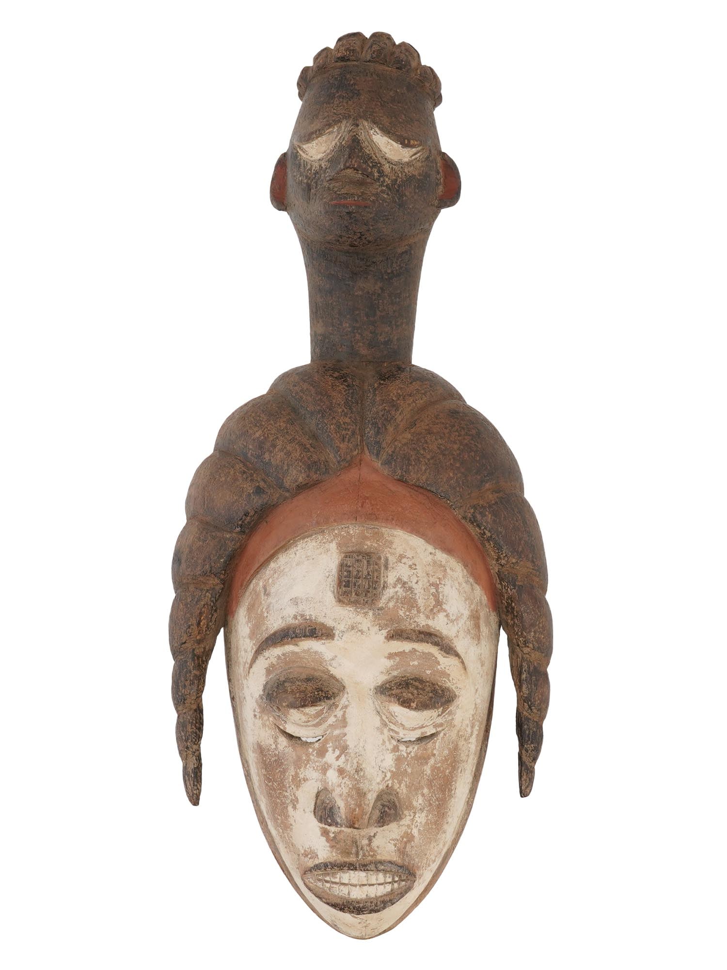 WEST AFRICAN NIGERIA CARVED WOOD IGBO MASK: A vintage hand-carved and painted wooden Igbo face mask. Igbo people, Nigeria. Presumably this lot is an Agbogho mmuo, a mask of a maiden spirit. Igbo men wear these masks at agricultural festivals an