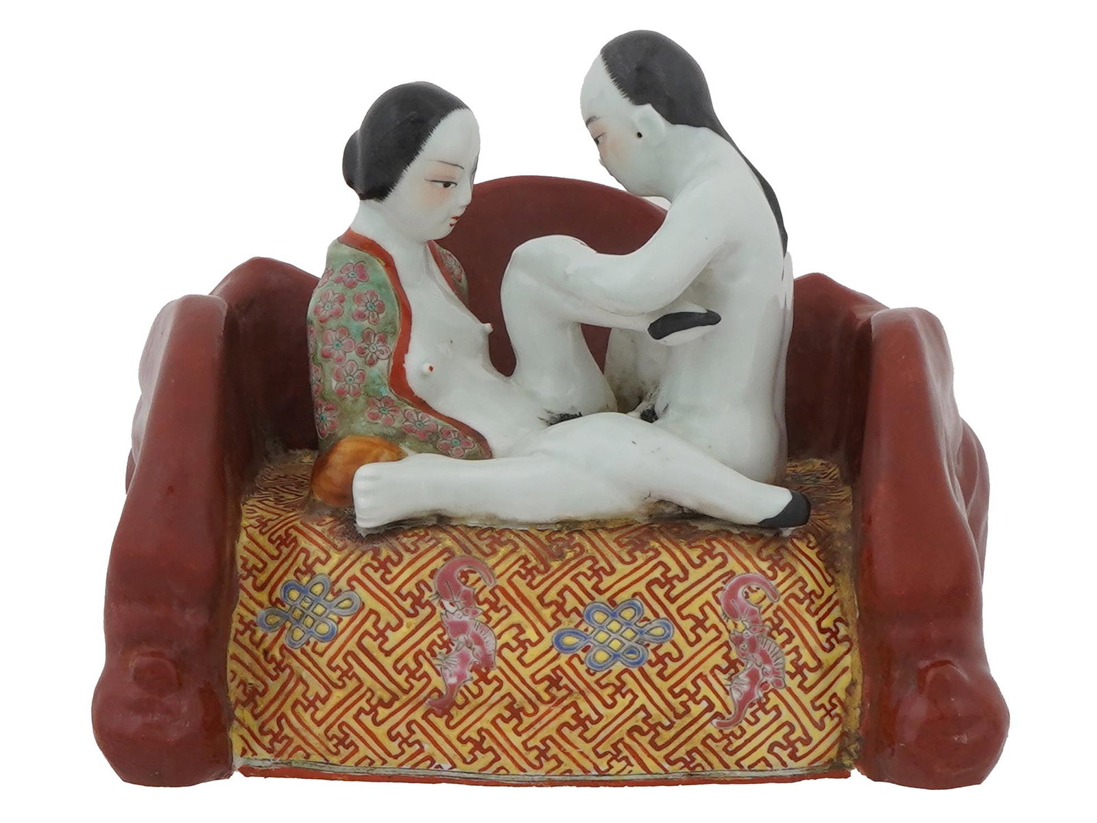 ANTIQUE CHINESE FAMILLE ROSE EROTIC FIGURAL GROUP: An antique Chinese Famille Rose porcelain erotic figural group. Circa the early 20th century. The artwork represents an erotic scene of a husband and wife on a sofa. Marked on the bottom. Asian Origin