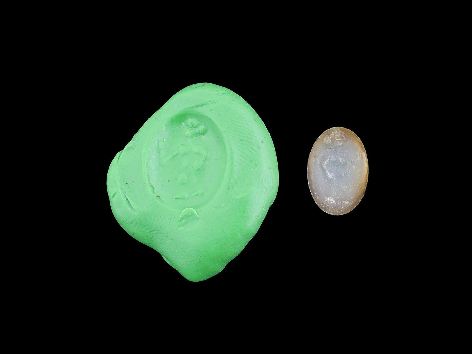 CARVED STONE INTAGLIO ANCIENT ROMAN HUMAN FIGURE: A carved stone intaglio featuring an ancient Roman depiction of a human figure. Such intaglios were used as personal seals, amulets, or decorative jewelry, showcasing the Romans appreciation for mytho