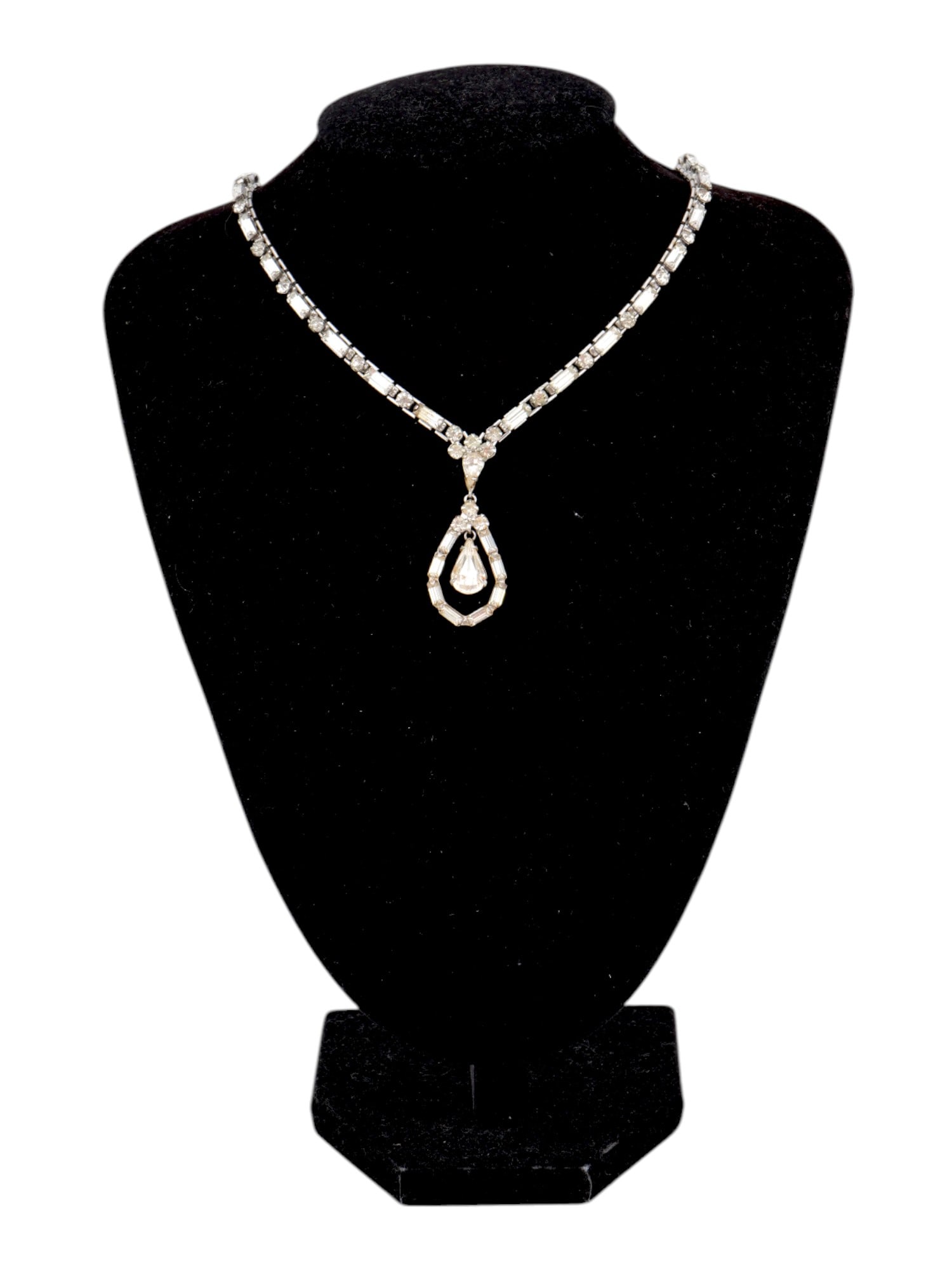 VINTAGE JEWELED CHOKER NECKLACE: A vintage silver-tone necklace of choker length set with transparent crystals. Baguette and round-cut stones, central drop pendant. Unmarked. Costume Jewelry For Women. THIS LOT IS ELIGIBLE FOR