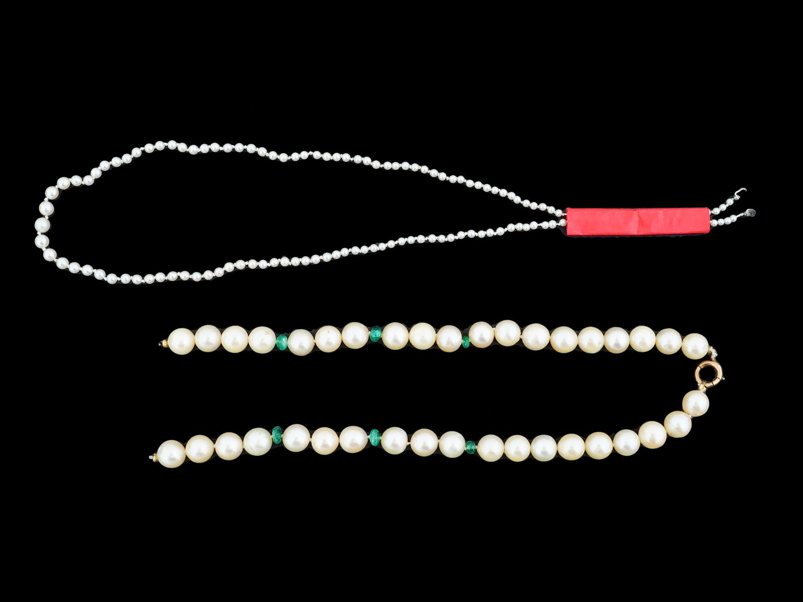 TWO STRANDS OF VINTAGE PEARL BEAD COSTUME JEWELRY: Two strands of vintage pearl bead costume jewelry. One strand of small white beads, increasing in size towards the bottom, and the second of larger cream beads alternating with smaller green beads. Vi