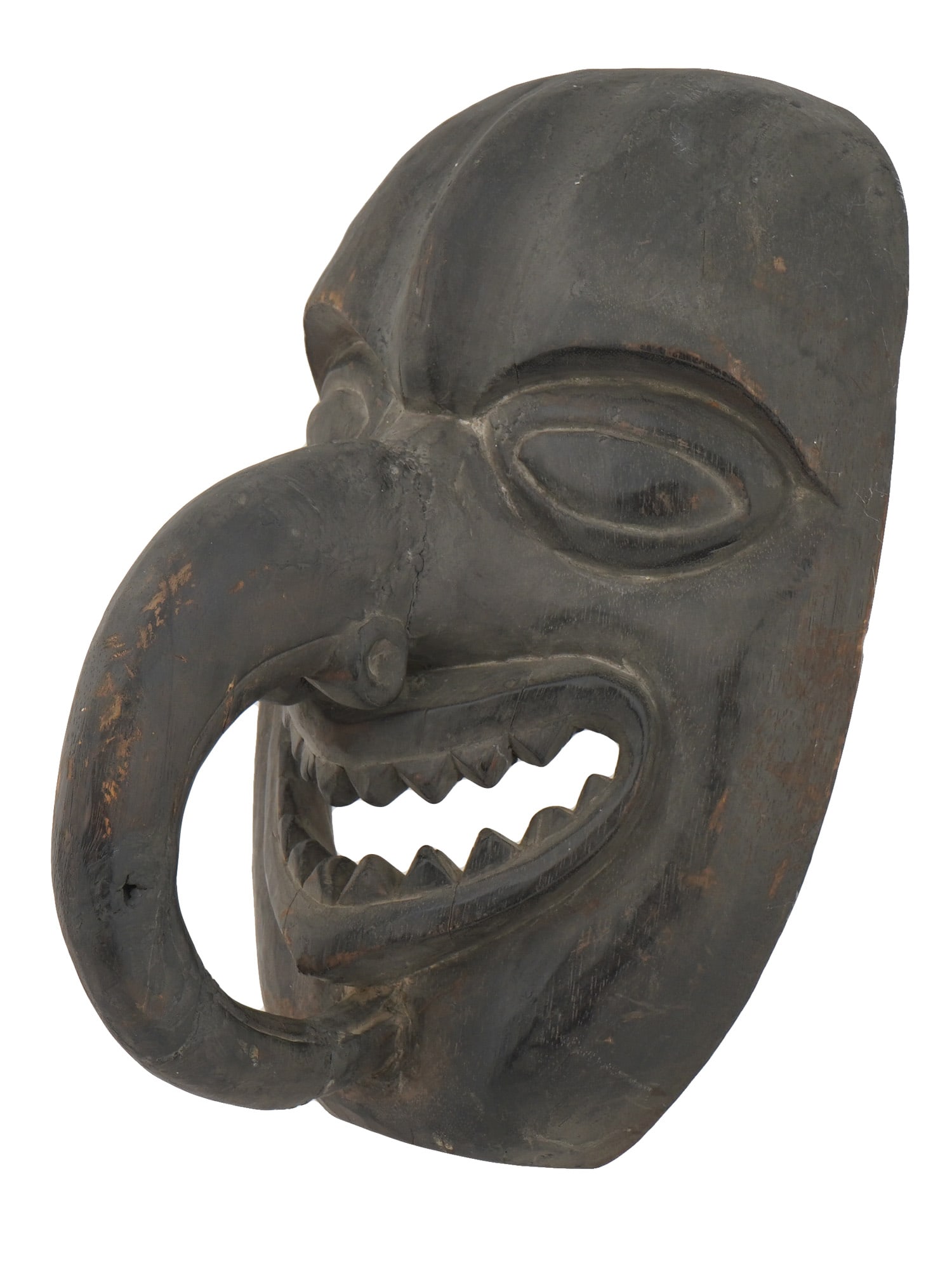 NORTHWEST COAST HAIDA ESKIMO DANCE CARVED WOOD MASK: A Northwest Coast Haida Eskimo dance carved wood mask. The mask is inspired by a birds head with large eyes, a beak like, huge nose curved towards the chin and a slit smiling mouth with sharp teeth. A