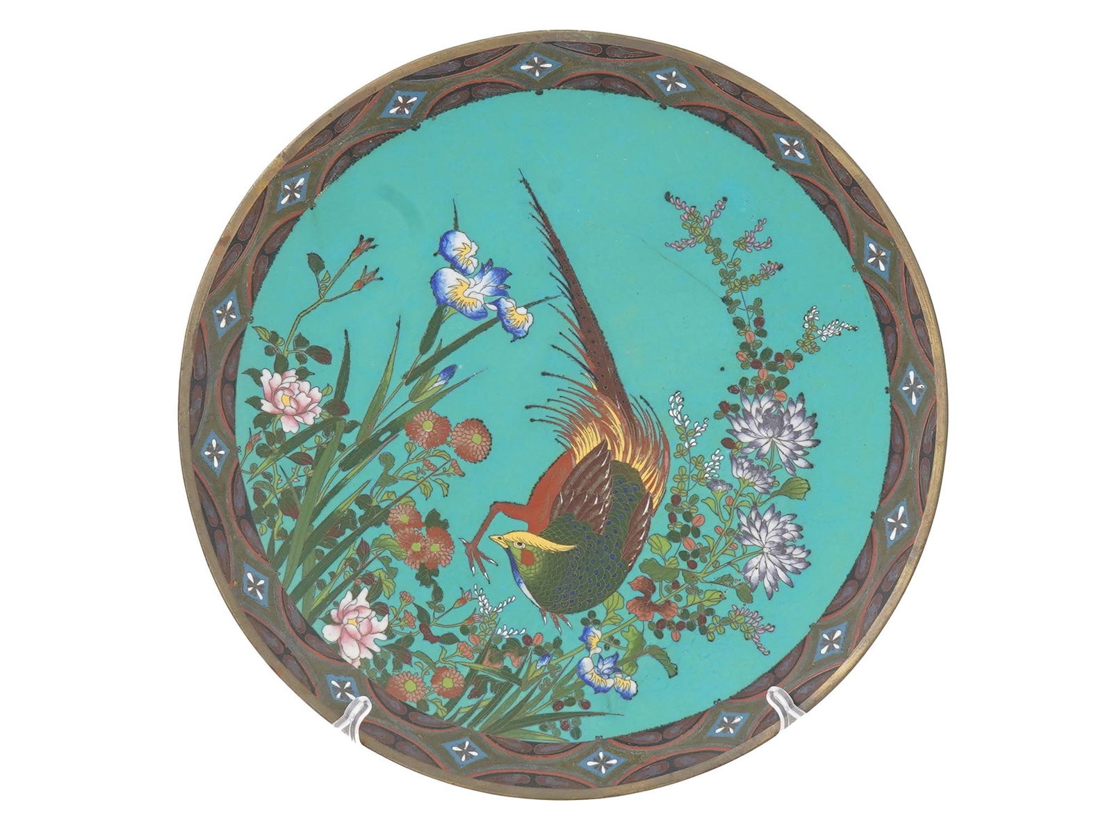 JAPANESE BIRD POLYCHROME CLOISONNE ENAMEL PLATE: A Japanese polychrome enamel plate. The plate is adorned with a polychrome enamel design representing a large bird in blossoming flowers made in the Cloisonne technique. The borders are adorned with f