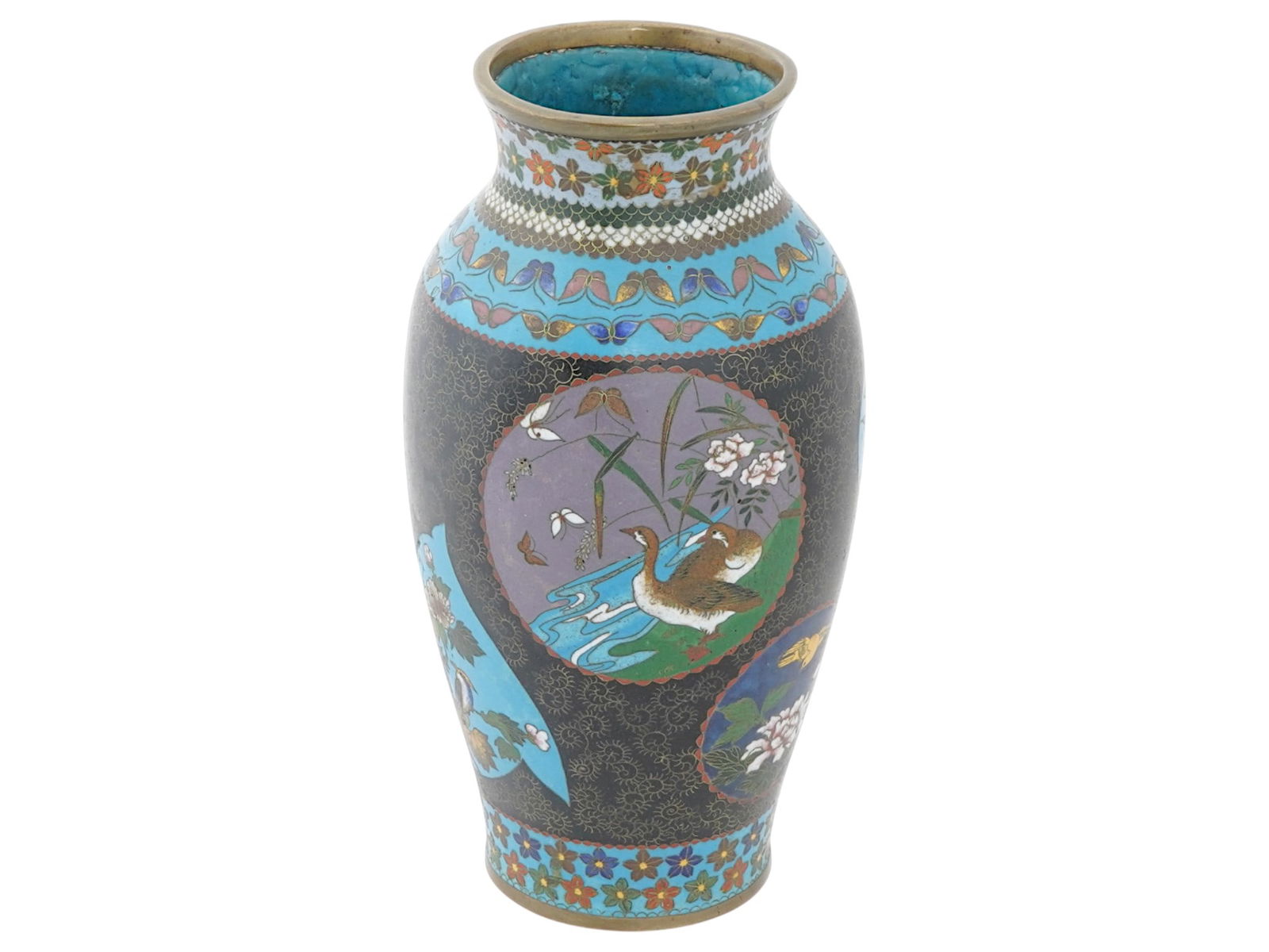 ANTIQUE JAPANESE MEIJI CLOISONNE ENAMEL VASE: An antique Japanese copper vase with polychrome cloisonne enamel design. Late Meiji era, before 1912. The body depicts medallions with birds, flower blossoms, and fish. Turquoise blue and black ground
