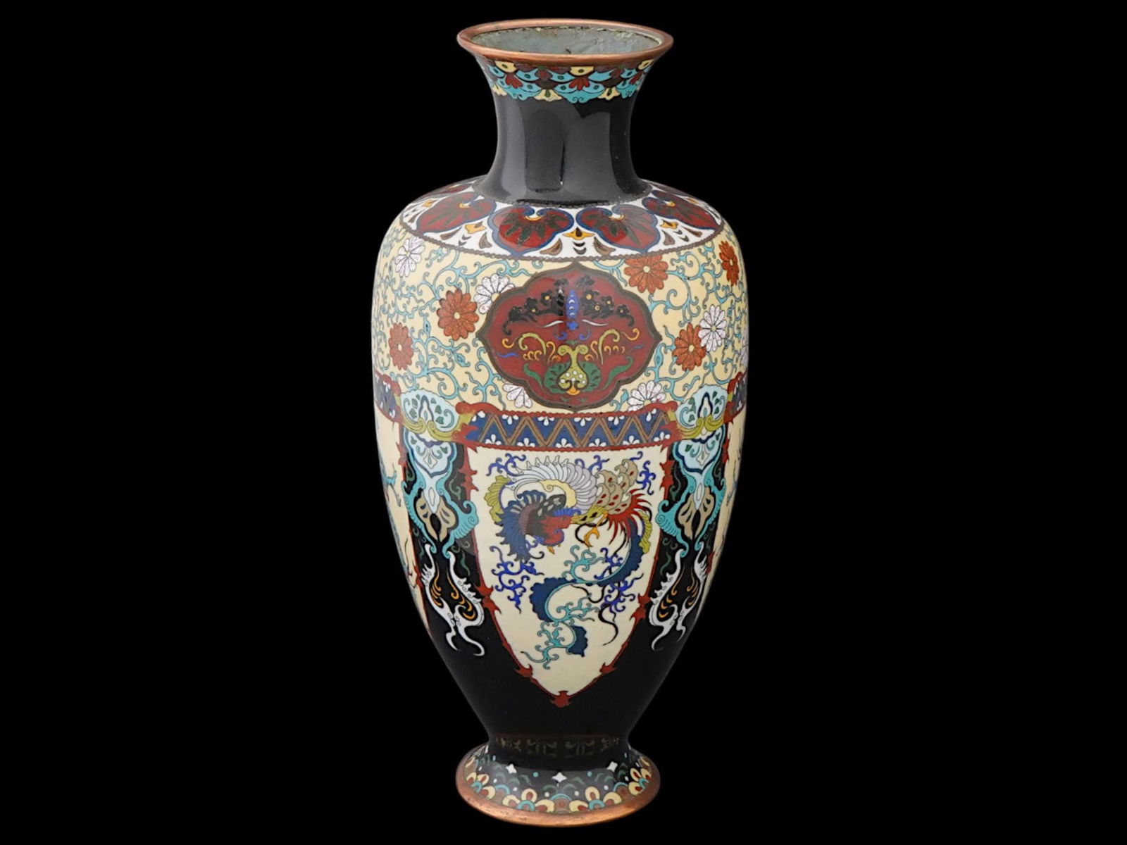 VINTAGE JAPANESE BLACK CLOISONNE ENAMEL VASE: A vintage Japanese black cloisonne enamel vase. Circa mid to late 20th century. The wide vase, raised on a base, with a tapered neck that widens slightly toward the top. It is lavishly decorated with