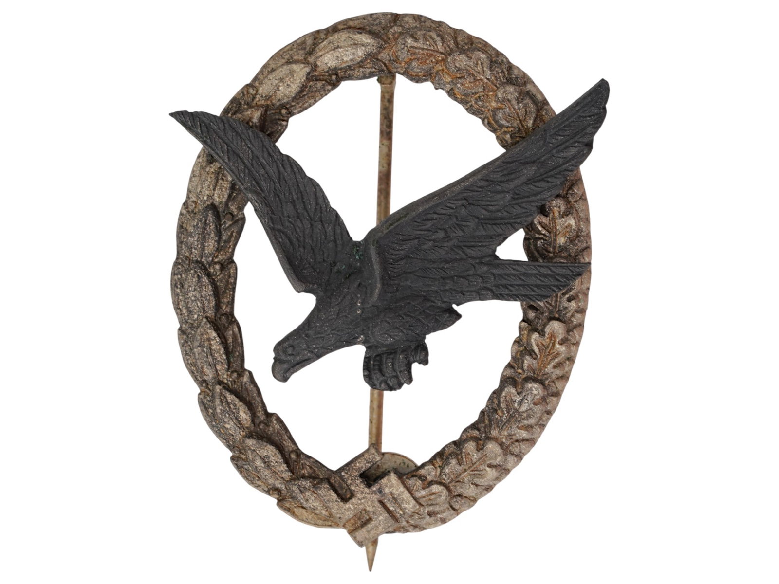 GERMAN WWII LUFTWAFFE PARATROOPER BADGE: A WWII German Army Paratrooper Badge. It has a diving eagle at the center surrounded by a laurel and oak leaves wreath. The wreath has the Nazi swastika embossed at the bottom center. The Paratrooper 