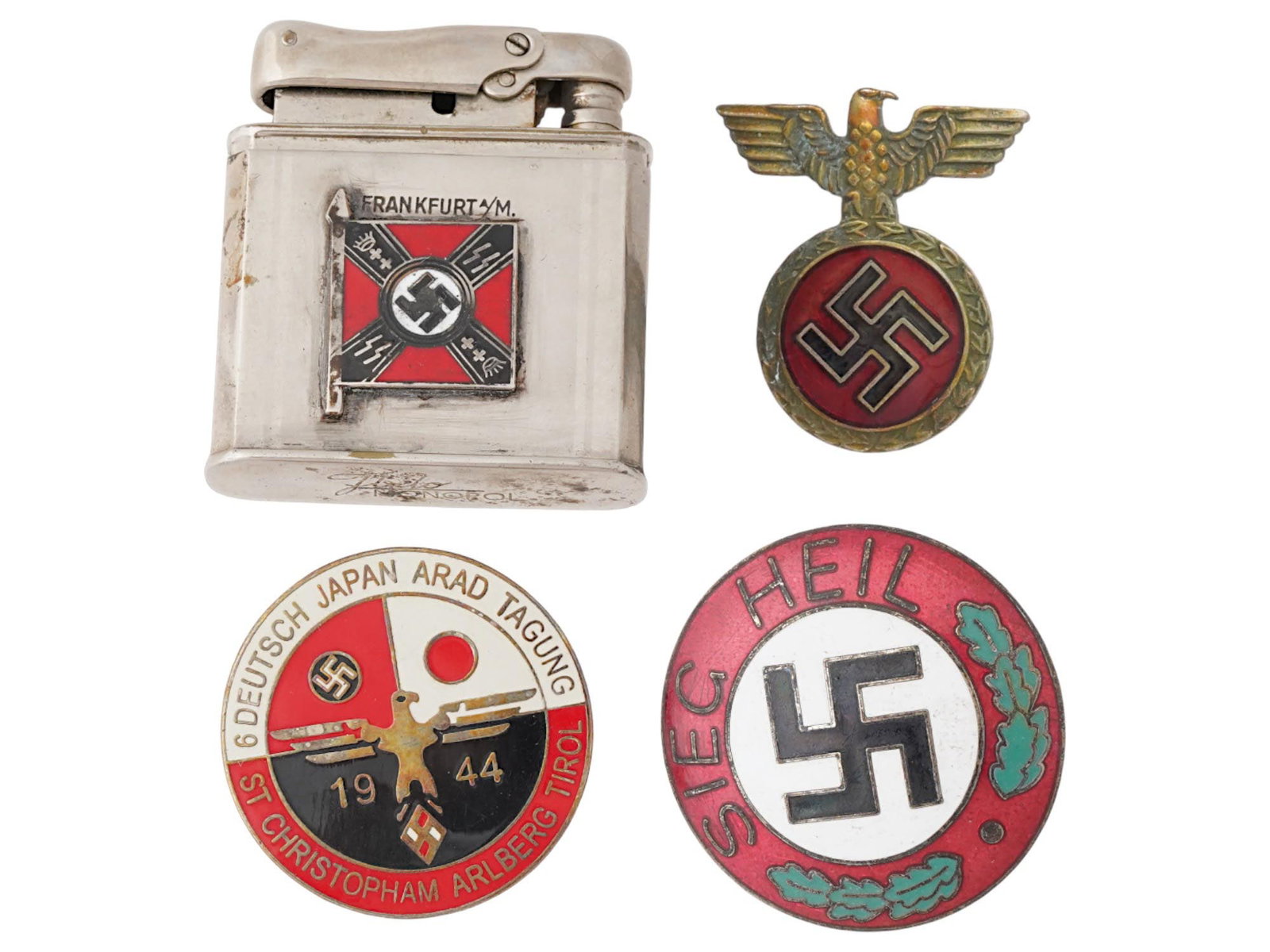 LOT OF FOUR WWII ERA GERMAN NAZI BADGES AND LIGHTER: A lot of four WWII era German Nazi items, specifically badges and a lighter. The lot includes a NDASP badge with an eagle and swastika, a memorable badge in honor of the meeting of students of Germany