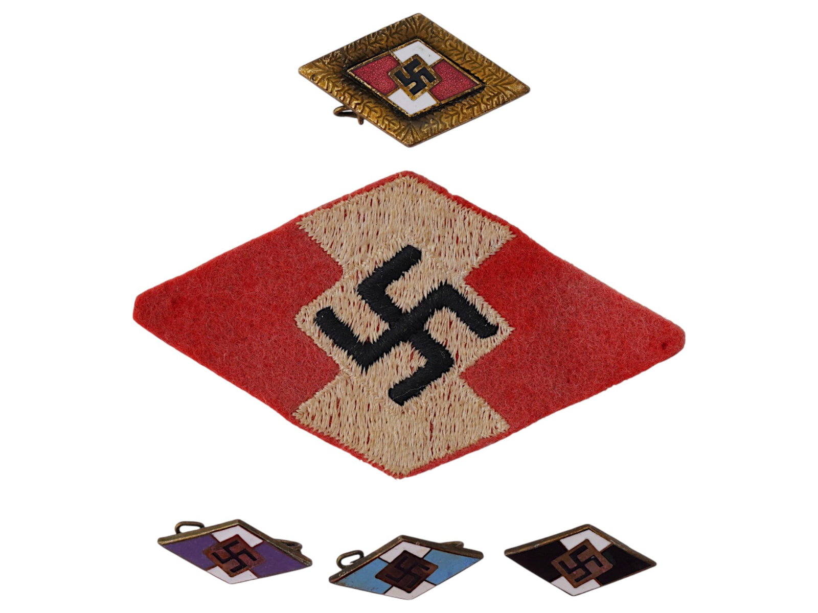 WWII GERMAN HITLER JUGEND BADGES AND PATCH: A group of WWII German Hitler Youth, Hitler Jugend badges, and a patch. A total of 5 items. The lot includes an Honor Badge, 1935, three Hitler Youth membership badges in various colors and an embroid